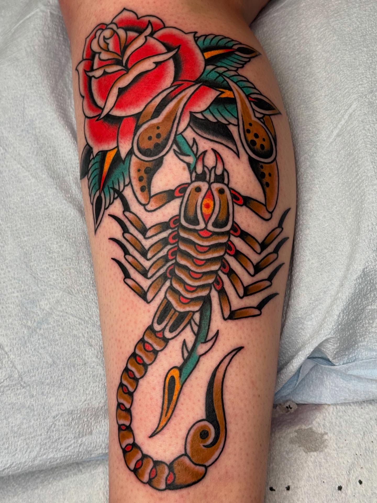 Scorpion and rose American traditional tattoo on the forearm by Emma Eaton