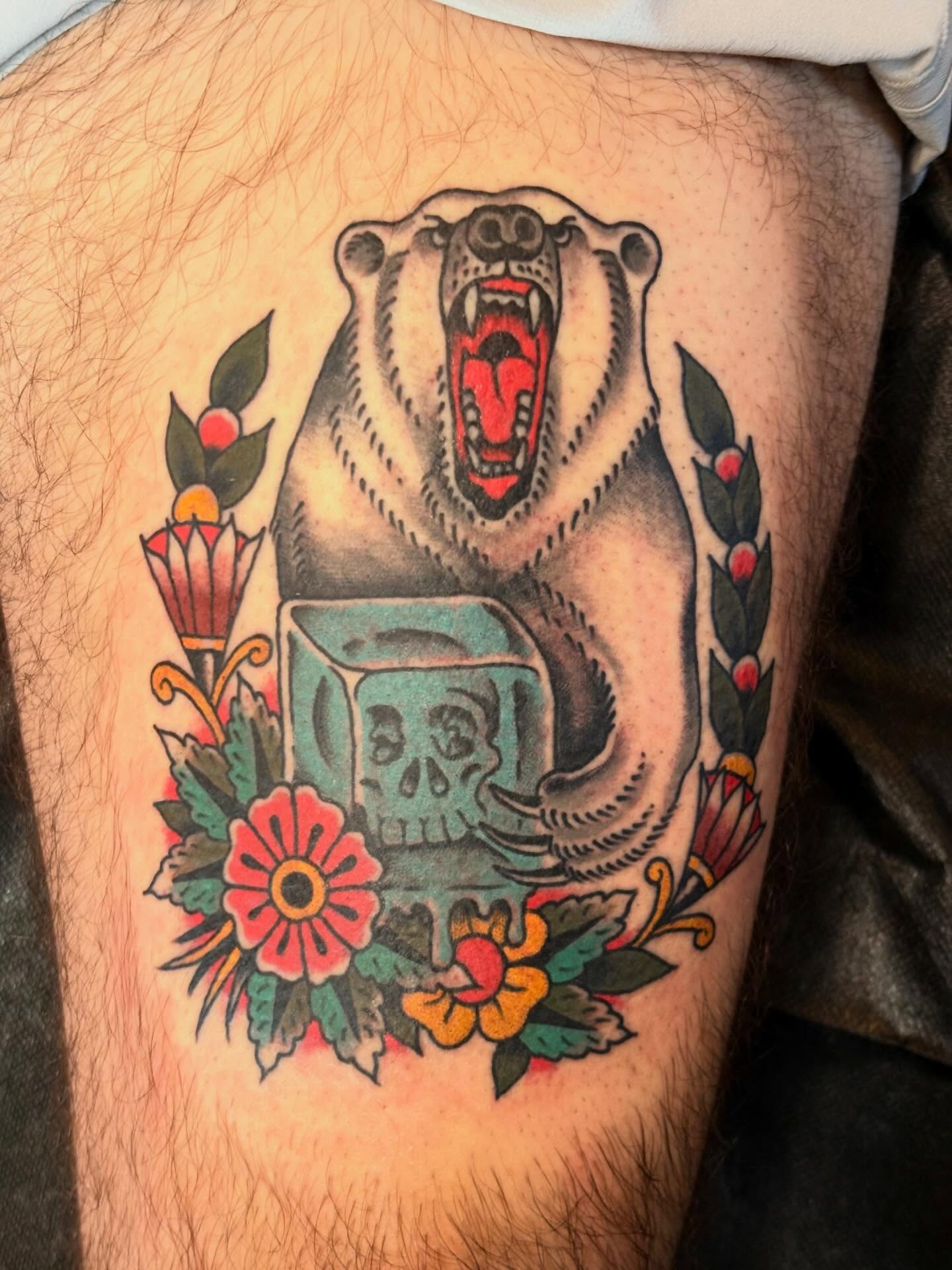 Roaring bear with skull American traditional tattoo on the thigh by Nick Rodin