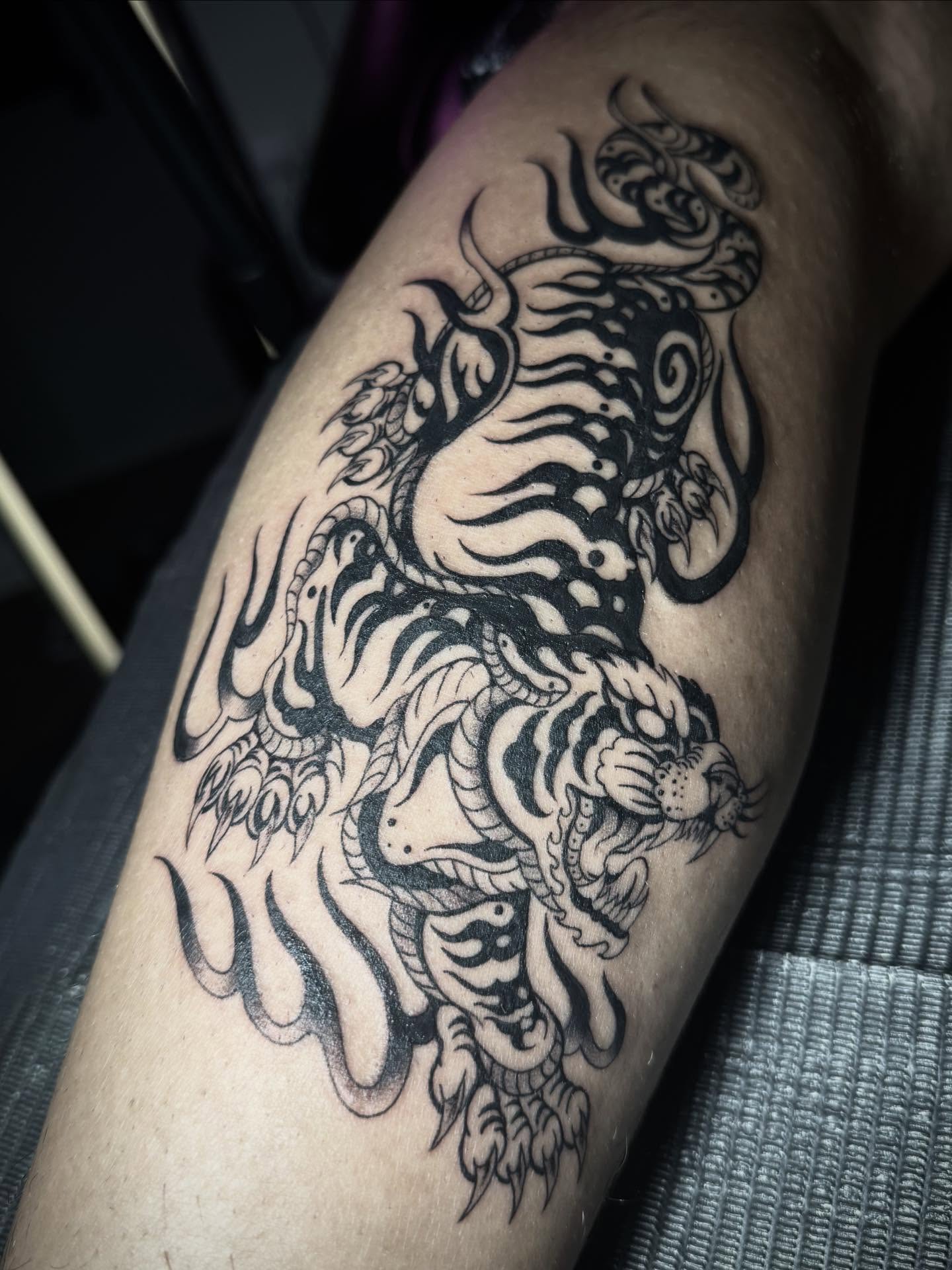 Tiger black and grey tattoo on the forearm by abbie michelle