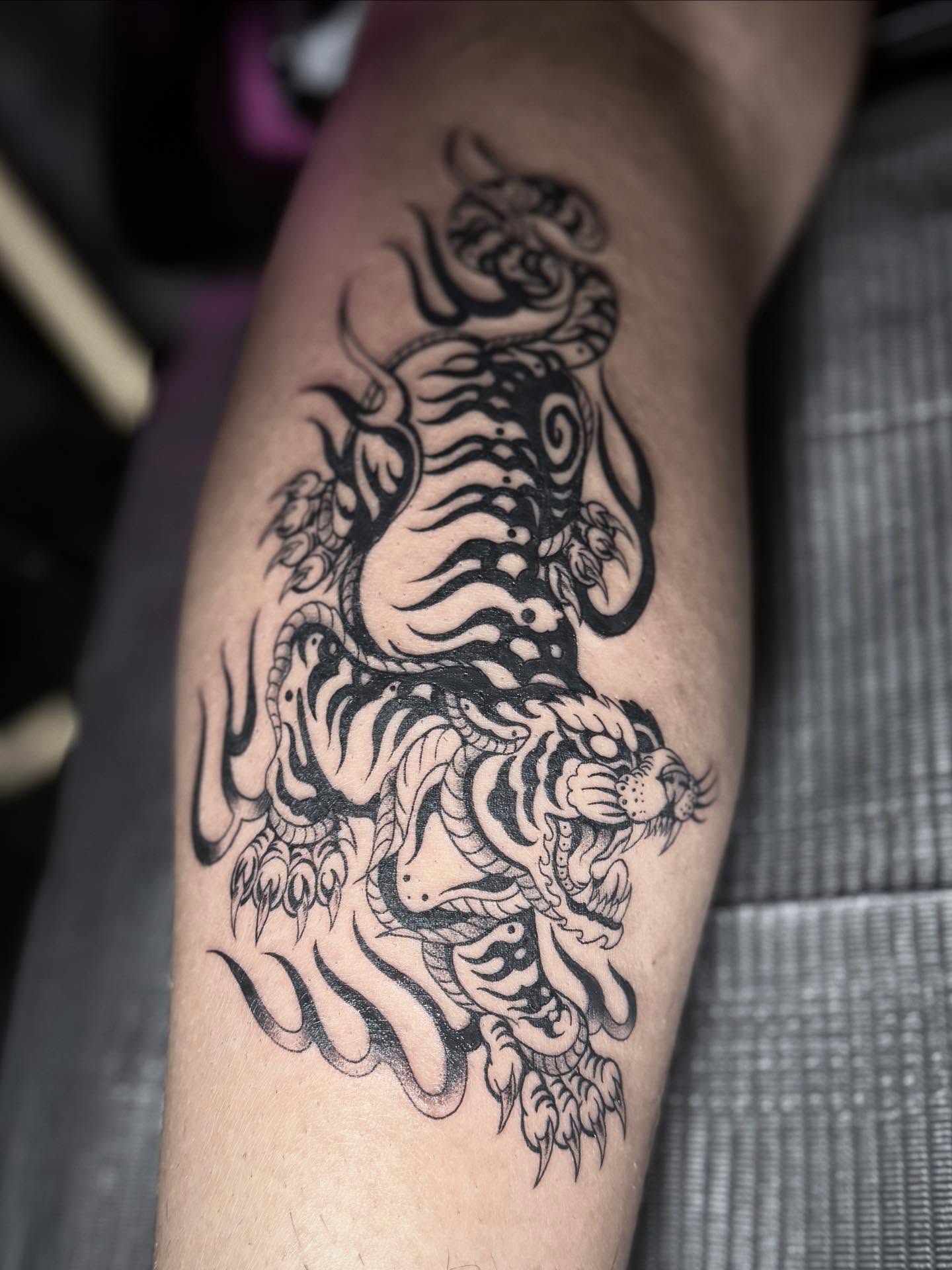 Tiger black and grey tattoo on the forearm by abbie michelle