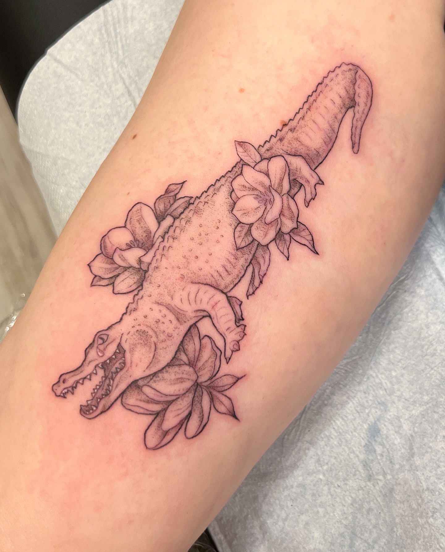 Alligator with flowers dotwork tattoo on the forearm by Kelsi Hooper, Seattle, Washington