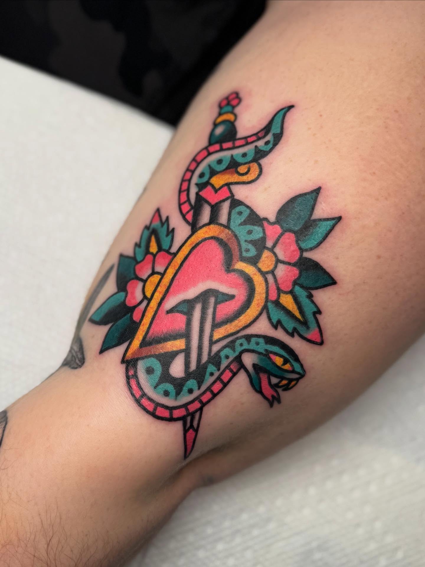 Peacock and floral American traditional tattoo on the forearm by Elle Yax