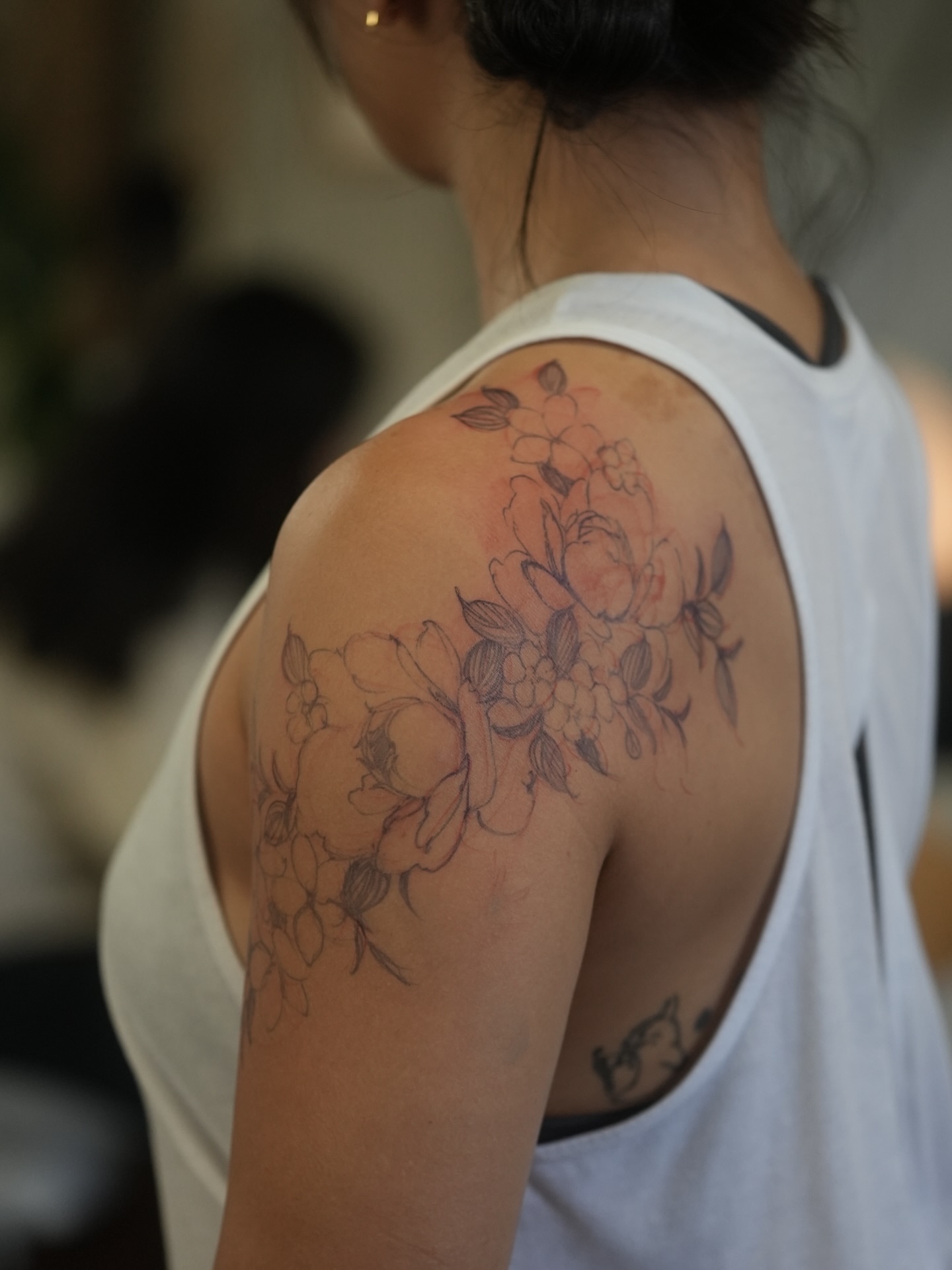 Floral bouquet watercolor tattoo on the shoulder by Mary Shekh