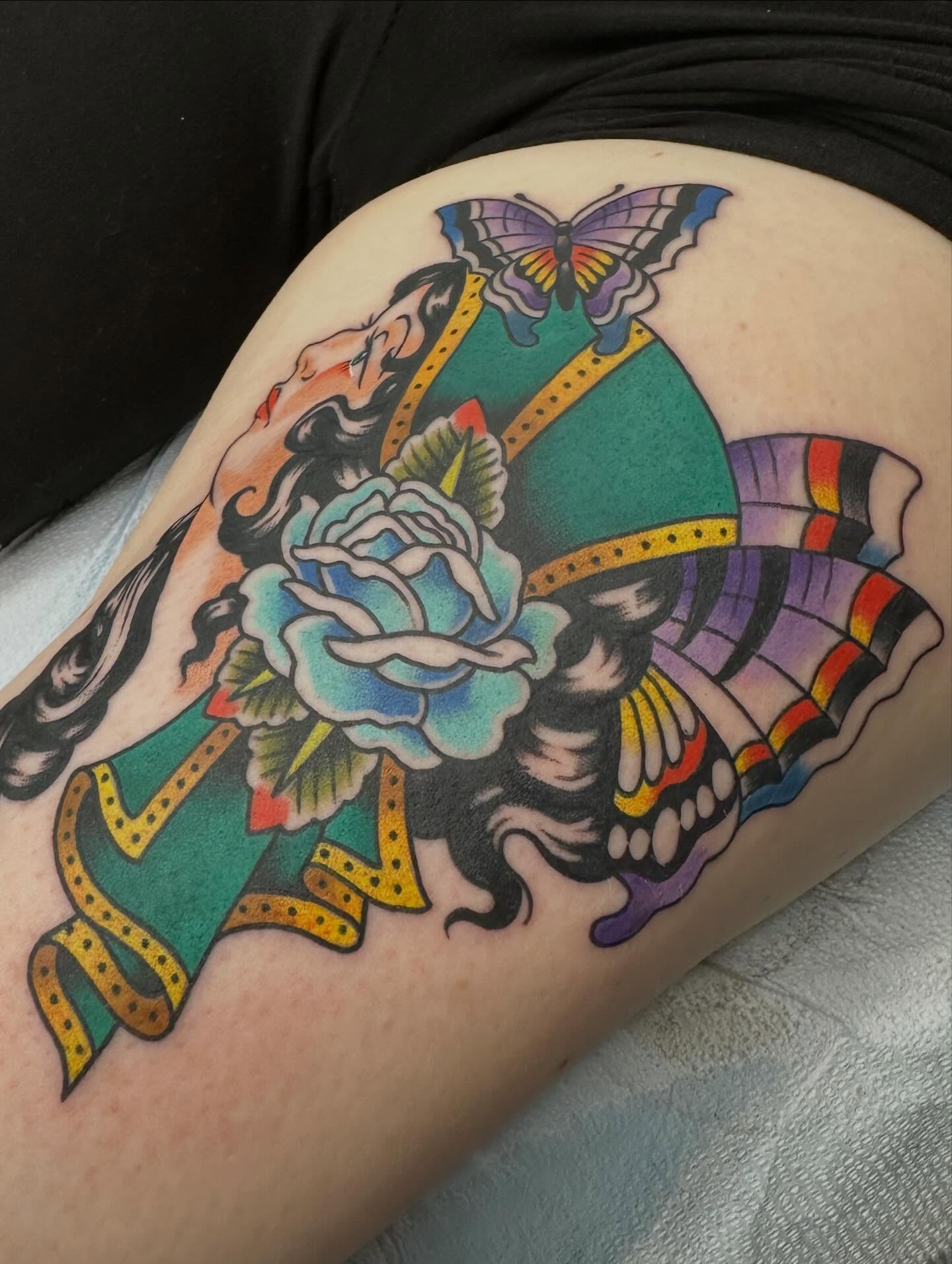 Rose and butterfly American traditional tattoo on the thigh by Sammy Beresford