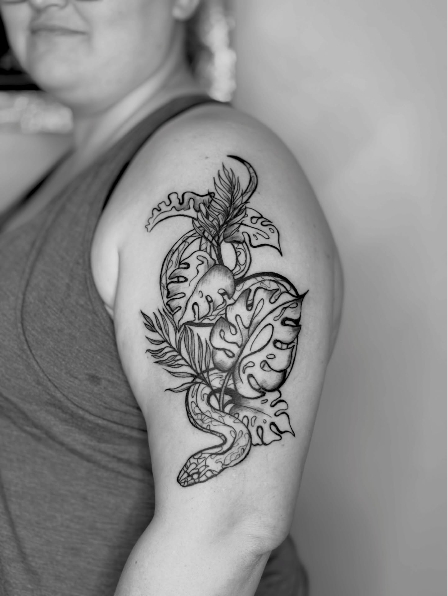 Snake and leaves realism tattoo on the shoulder by Sarah