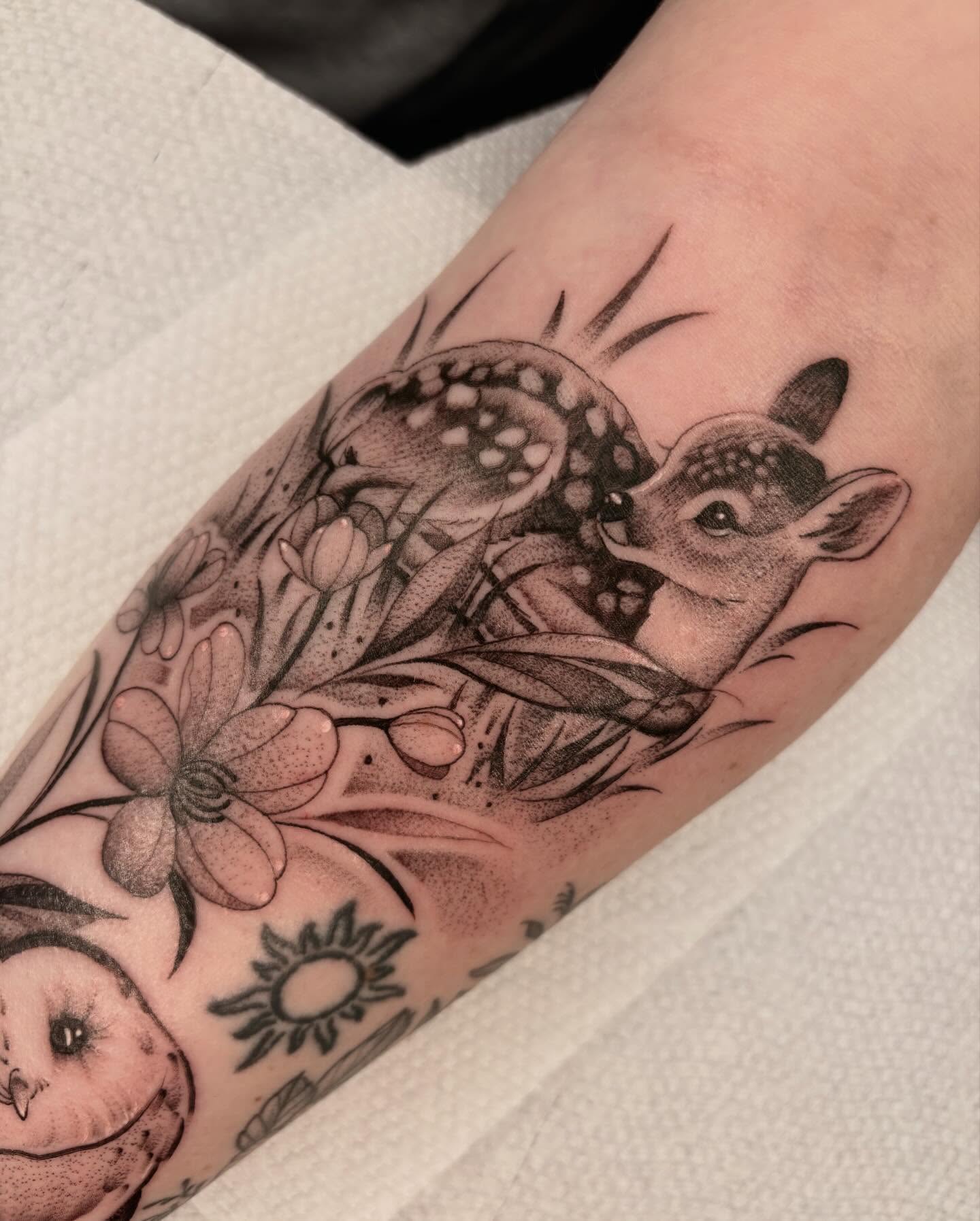 Deer and flowers dotwork tattoo on the forearm by Avery Mullins
