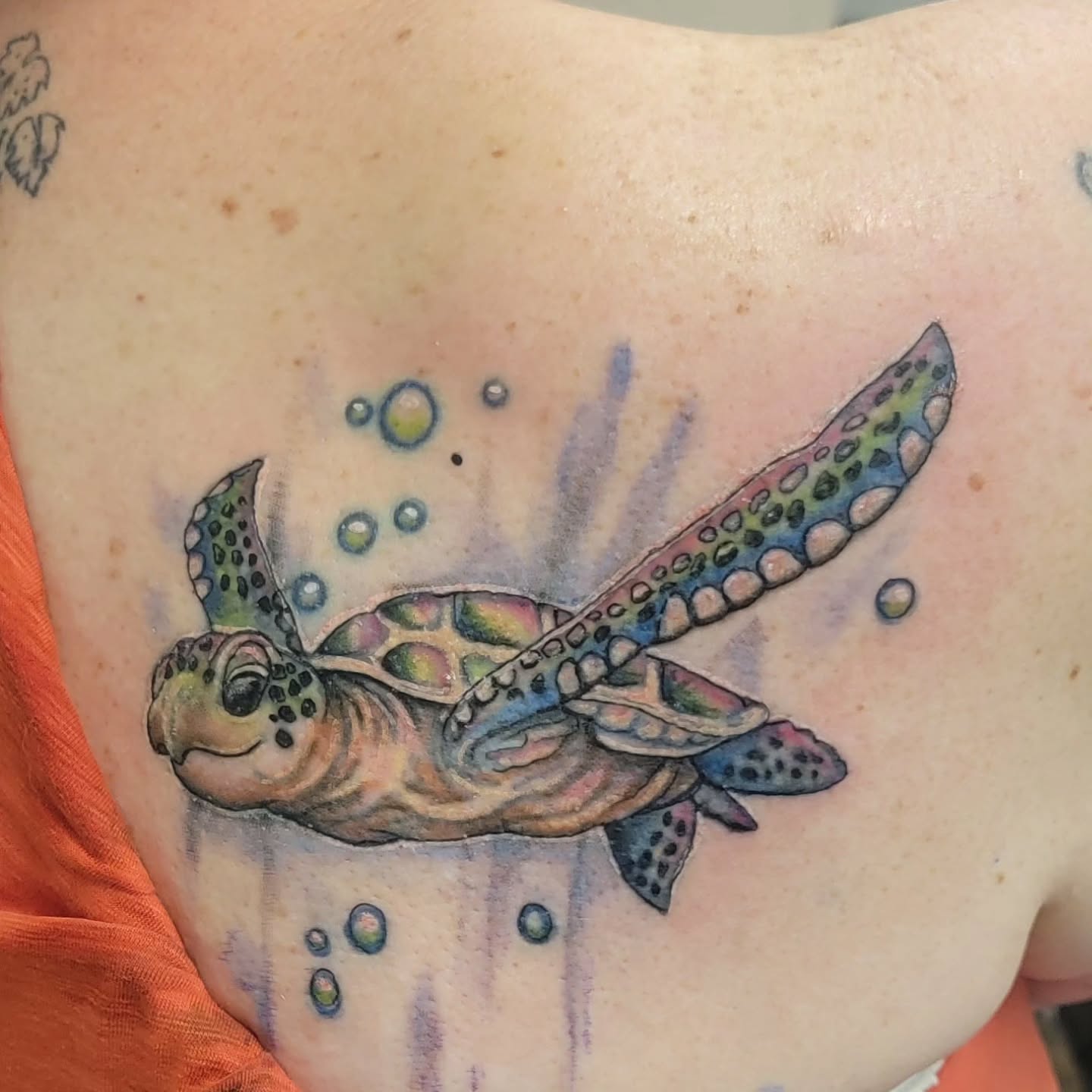 Sea turtle with bubbles fine line tattoo on the chest by Hatchetfoot Art