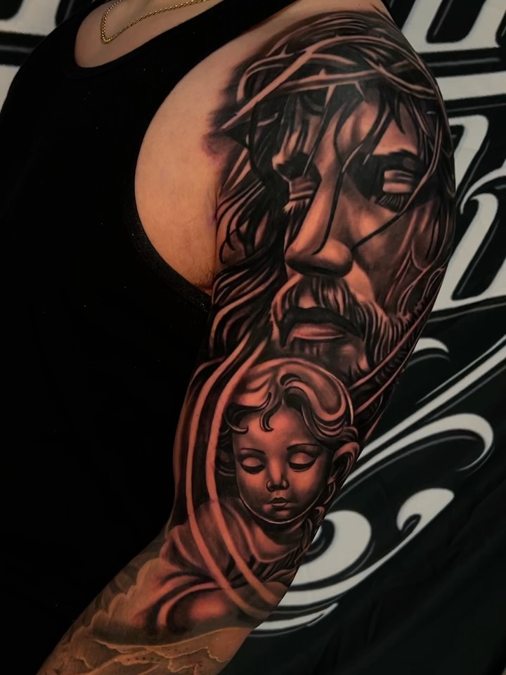 Religious figures realism tattoo on the upper arm by Daniel Michael Perez