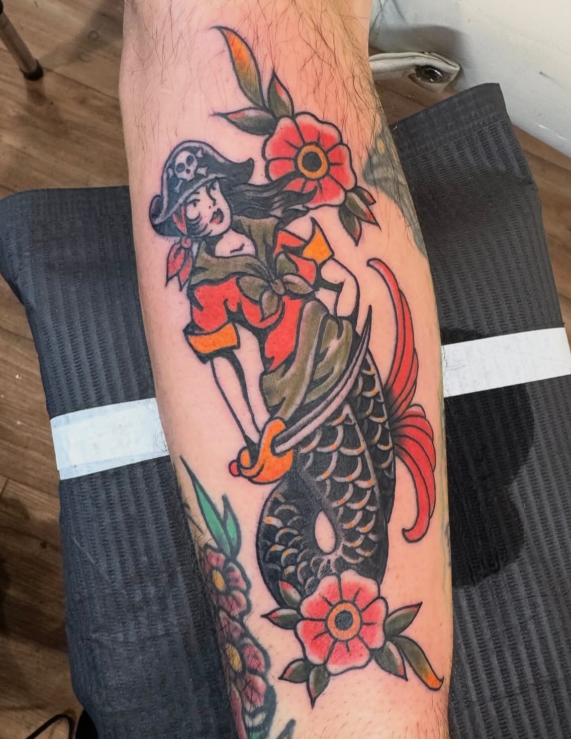 Pirate girl and koi fish American traditional tattoo on the forearm by Brian DiCola Tattooer