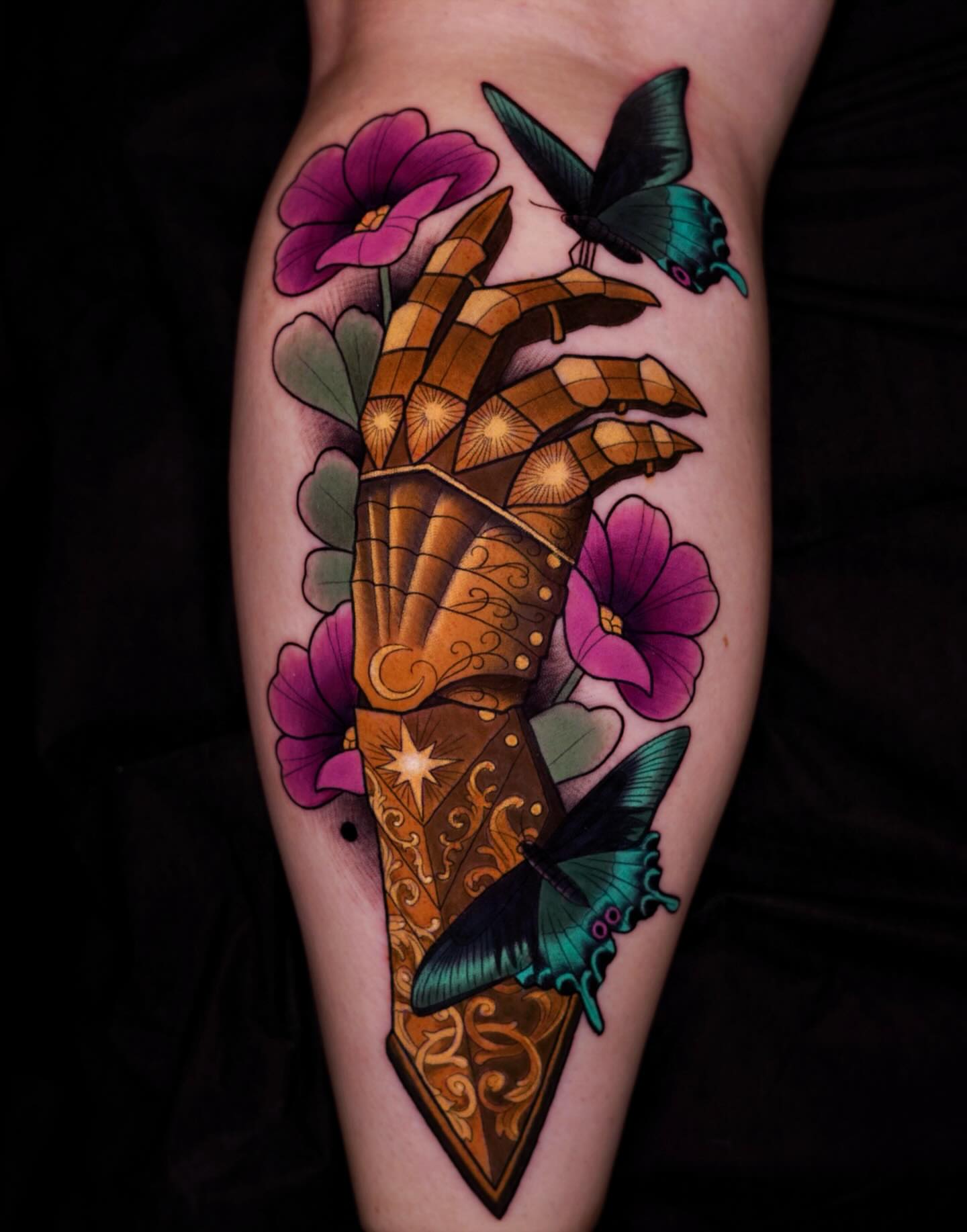 Hand with butterfly American traditional tattoo on the forearm by Brooke Borden