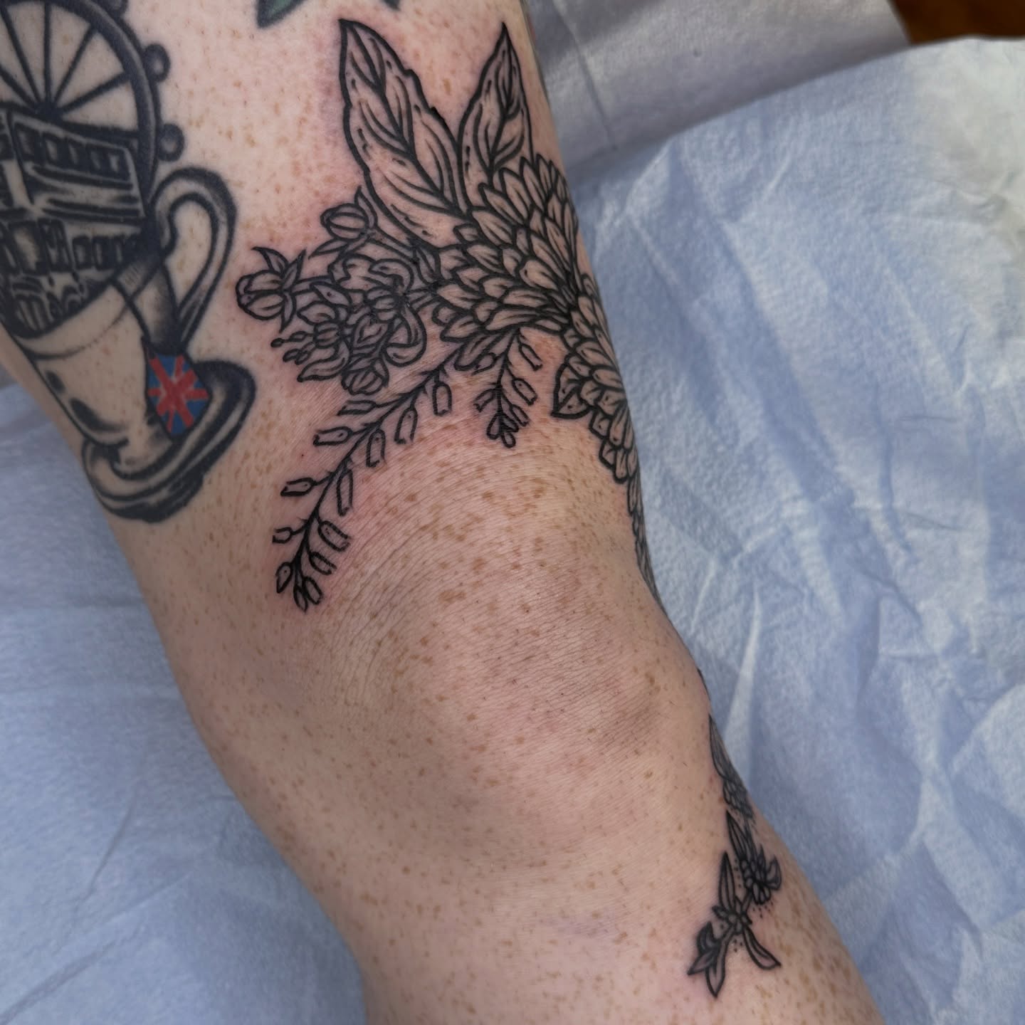 Floral arrangement black and grey tattoo on the forearm by rosalie
