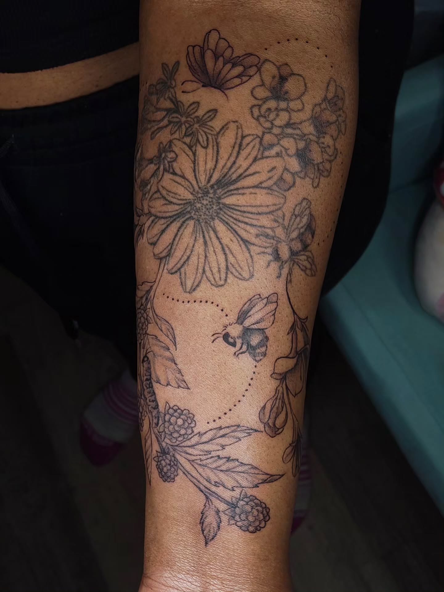 Flowers and bee black and grey tattoo on the forearm by Luna 🌙