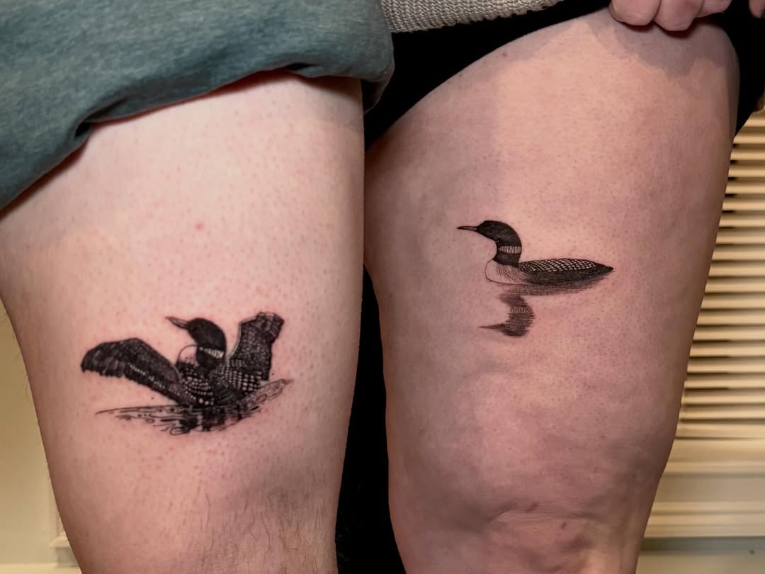Loons in water fine line tattoo on the thigh by Ana Blatt