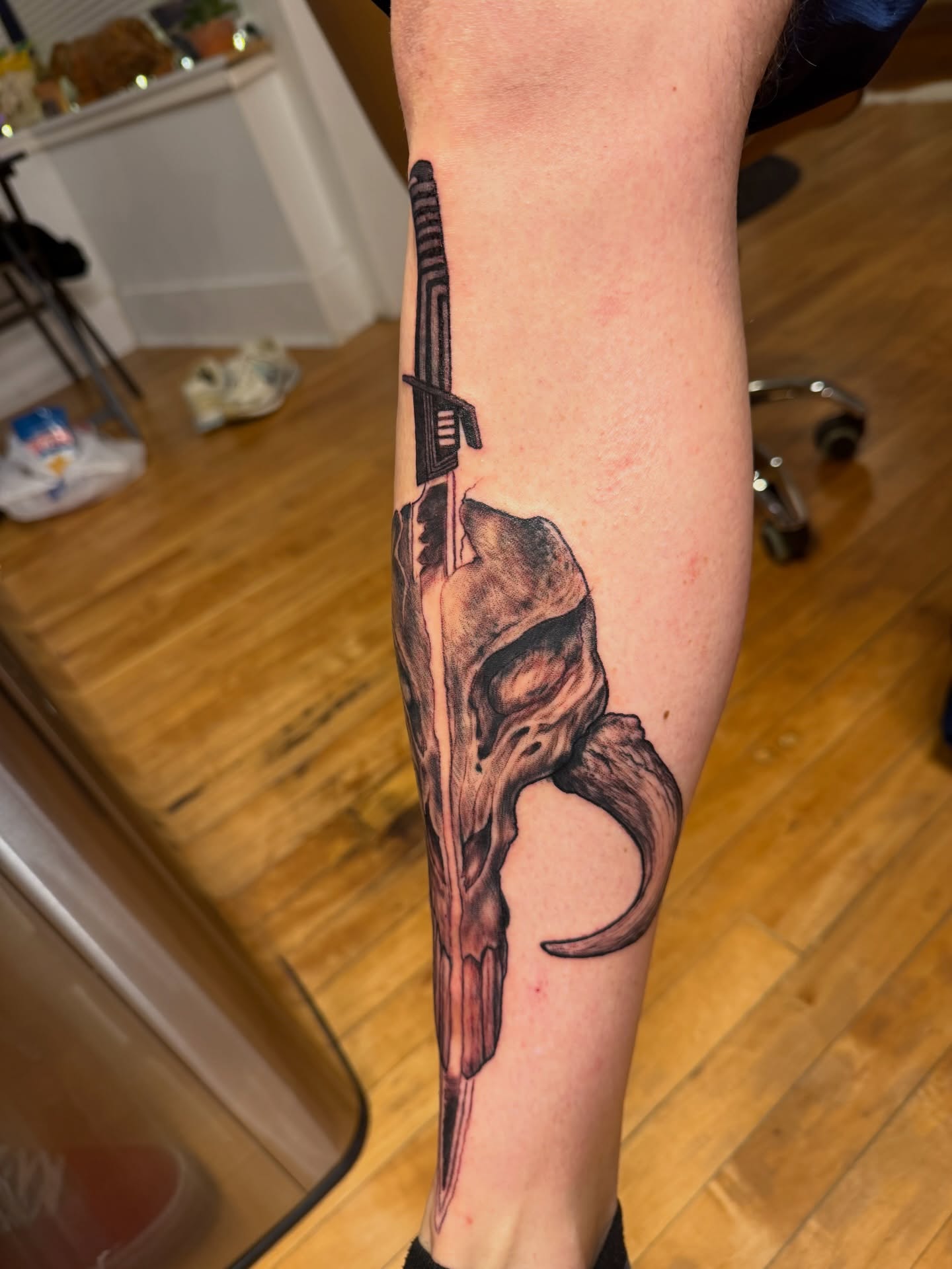 Gun and helmet realism tattoo on the forearm by steven