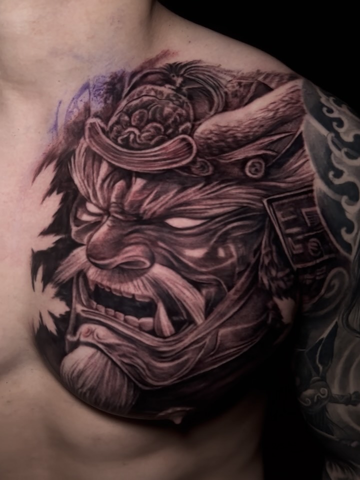 Demon mask dark realism tattoo on the chest by El Bryan Tattoos