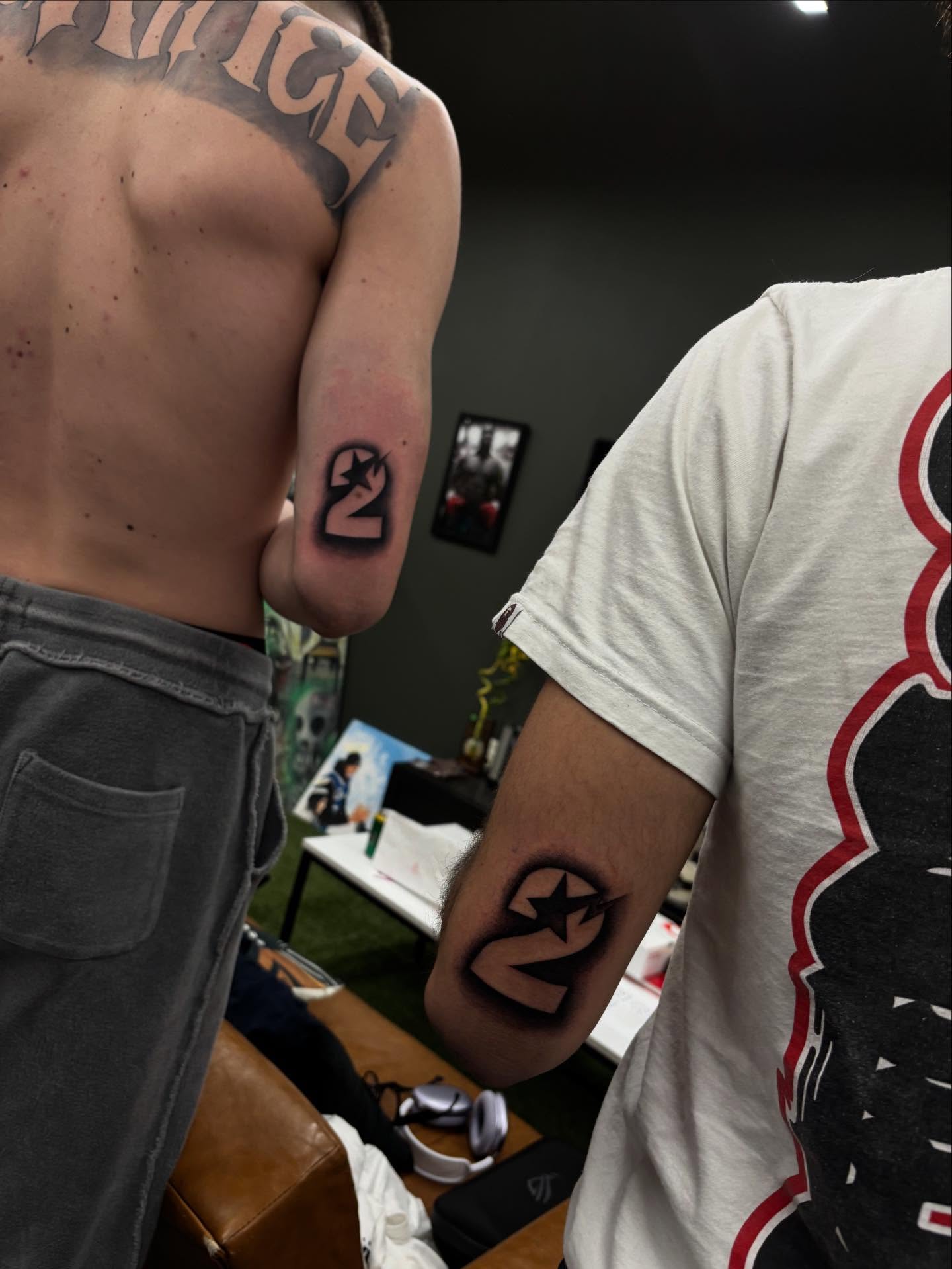 Number 2 with star black and grey tattoo on the forearm by orlando
