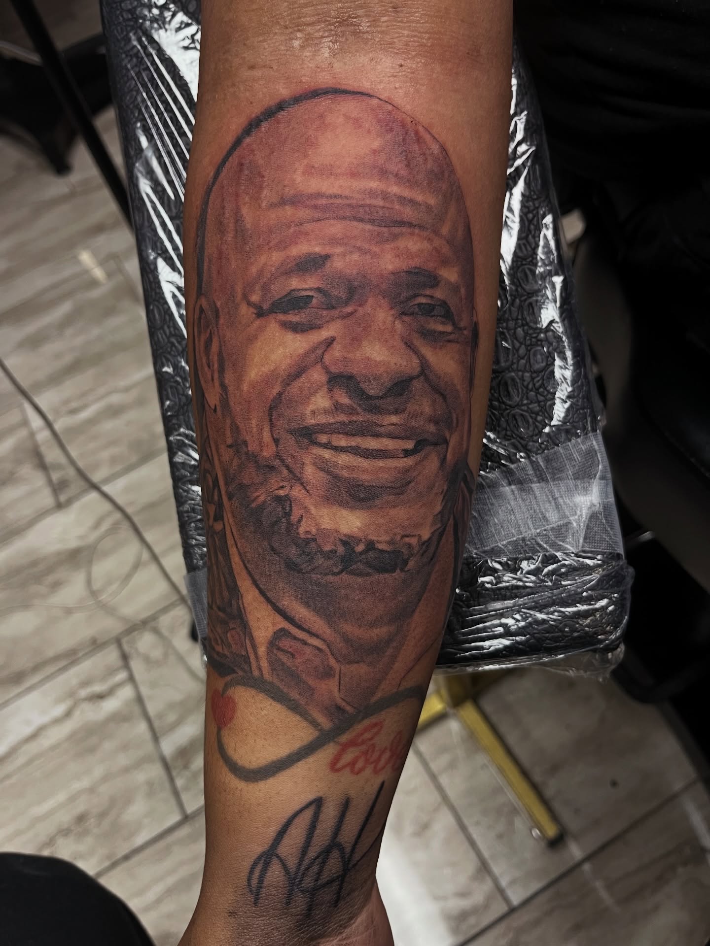 Portrait realism tattoo on the forearm by Quinten Harper