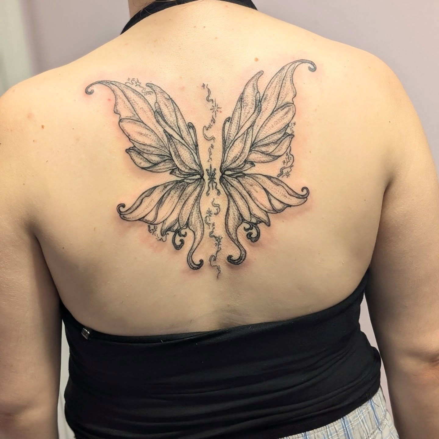 Butterfly dotwork tattoo on the back by Ryan