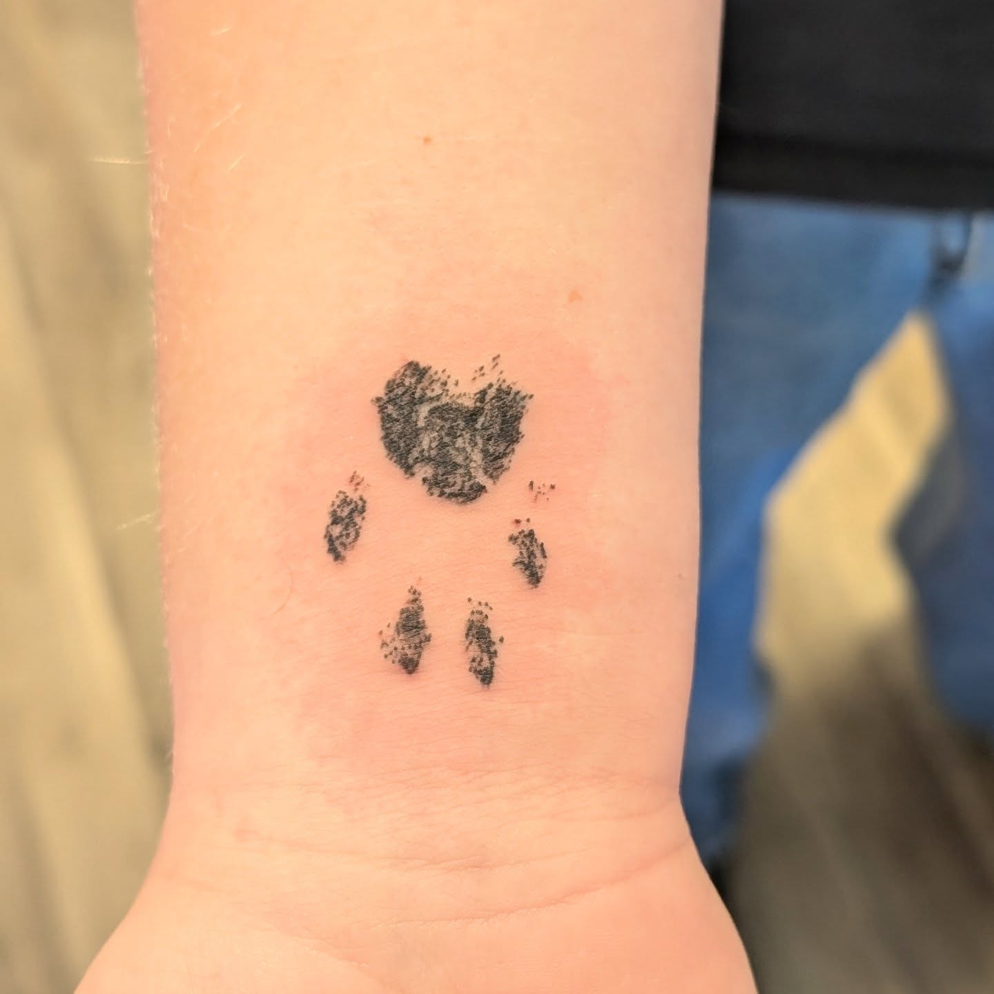 Bear paw print dotwork tattoo on the forearm by Ryan