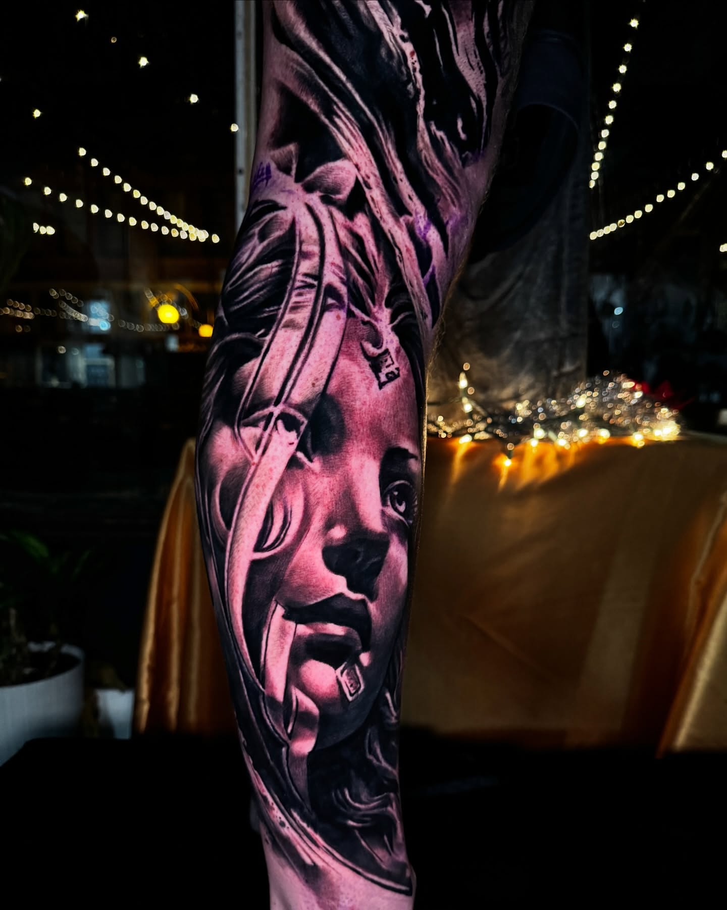 Portrait realism tattoo on the forearm by Donald Reynolds