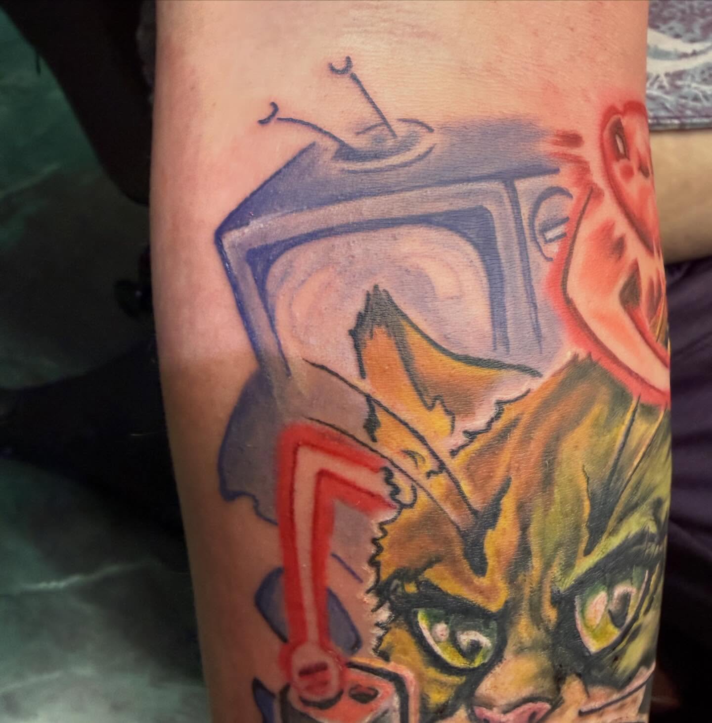 Cat and television new school tattoo on the forearm by Devon Beyer, Mission, Kansas