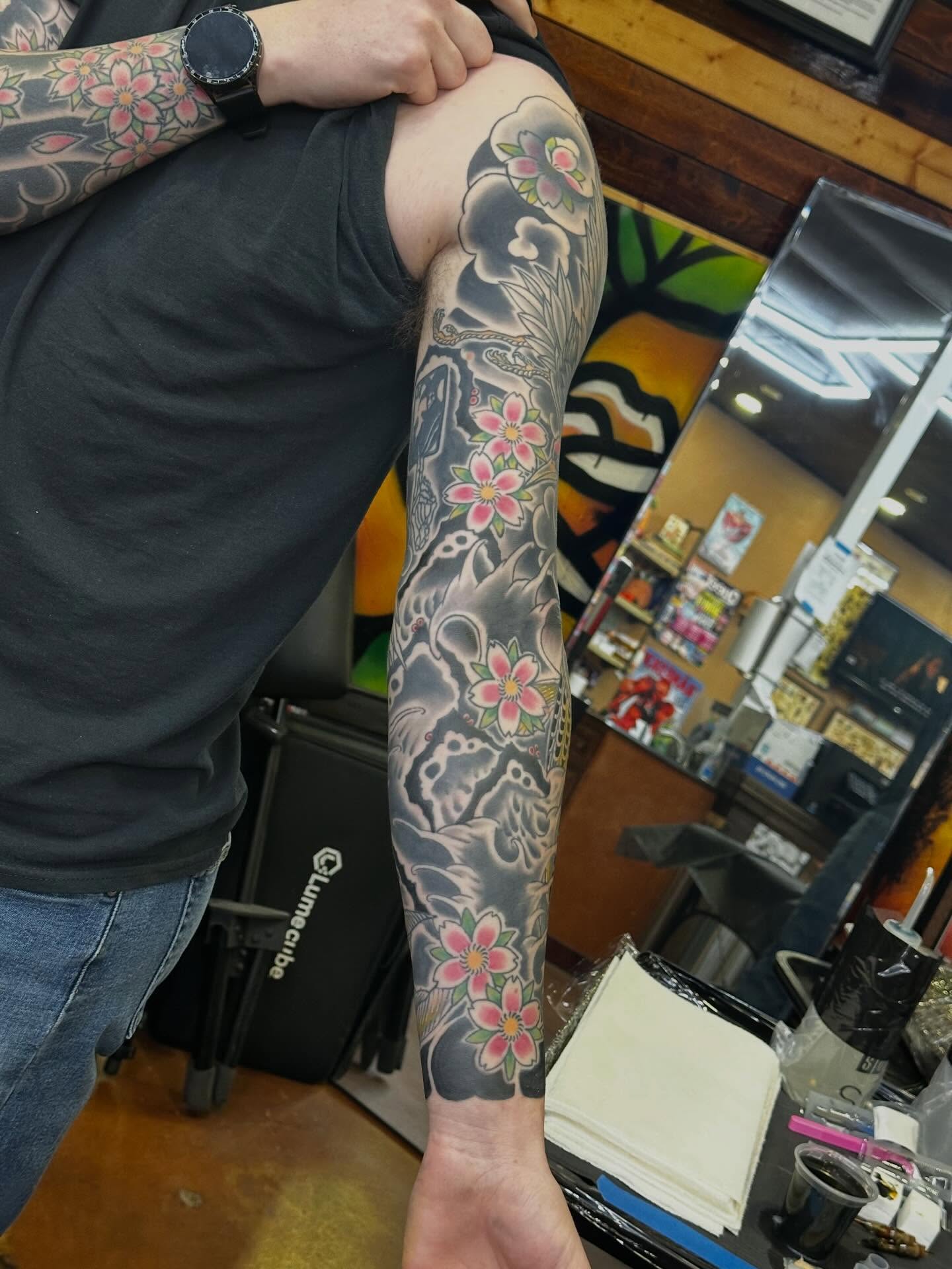 Cherry blossoms and clouds Japanese tattoo on the forearm by Wesley Lam