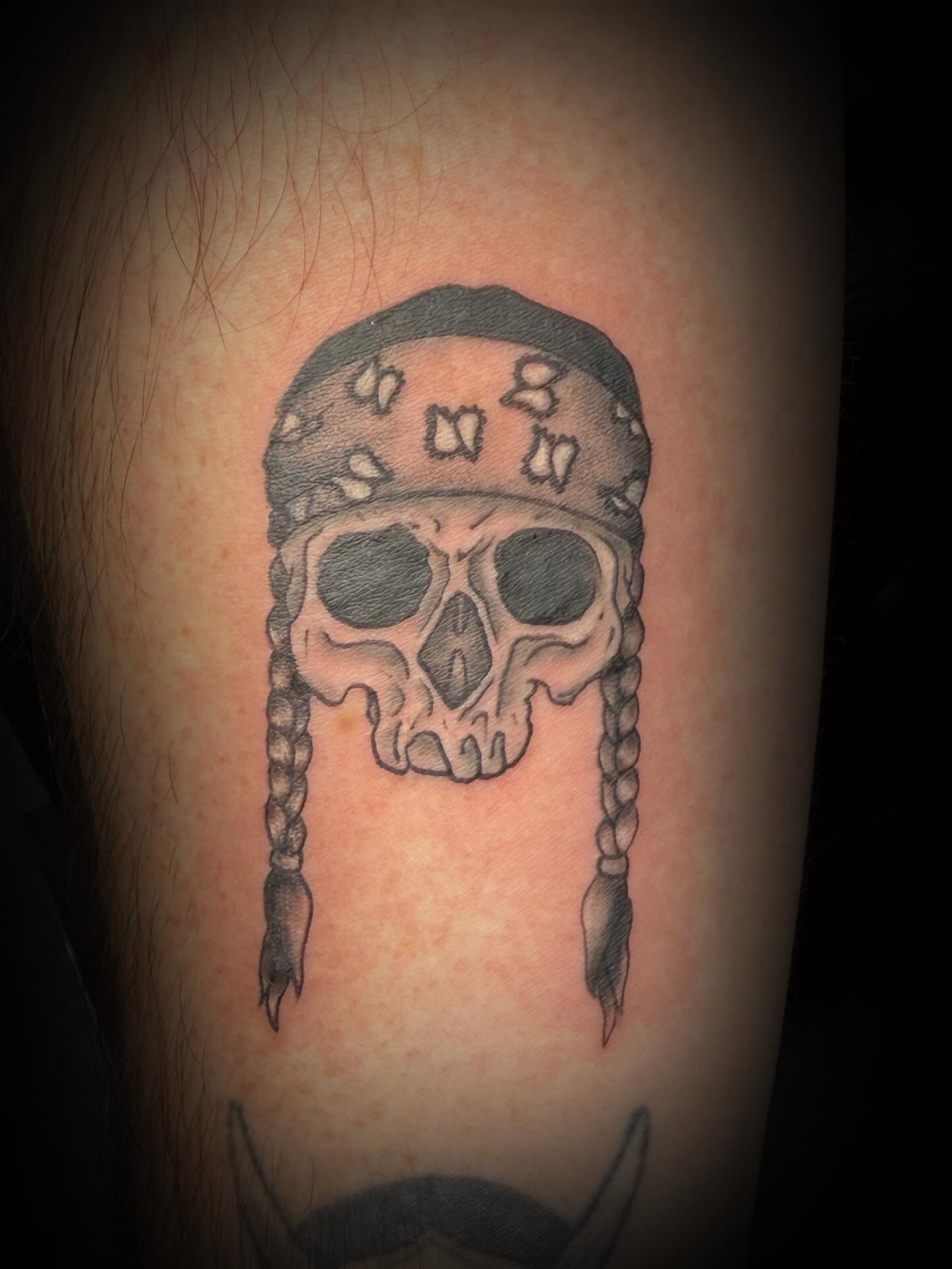 Skull with bandana black and grey tattoo on the forearm by sᴋᴇᴛᴄʜᴇᴅ