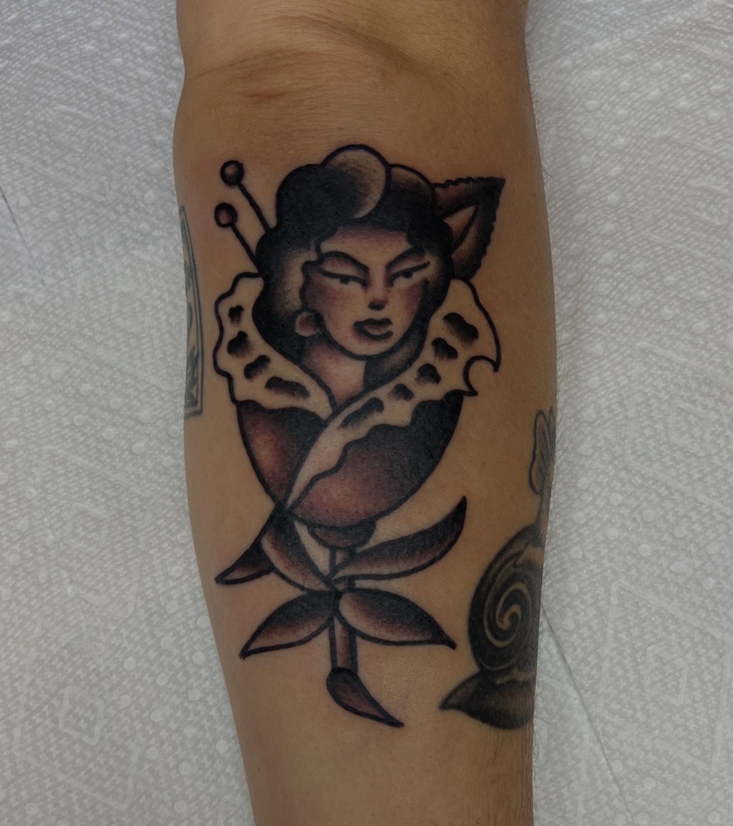 Woman in flower American traditional tattoo on the forearm by Tattoo