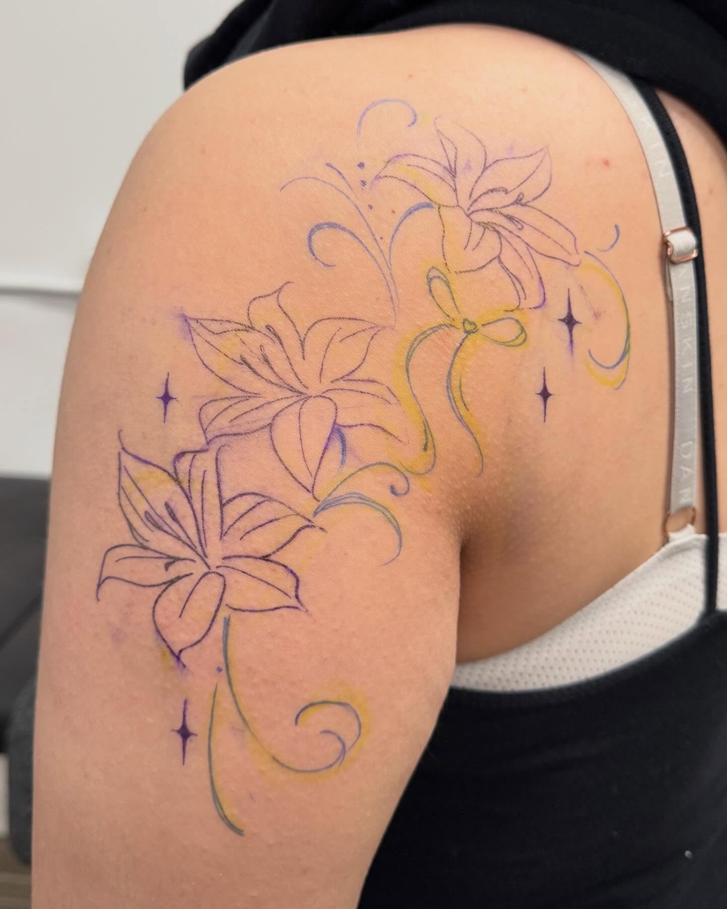 Lilies new school tattoo on the shoulder by RyAnn Lynn