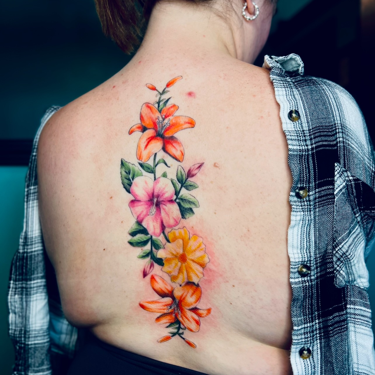 Floral arrangement realism tattoo on the back by Sydney Rose