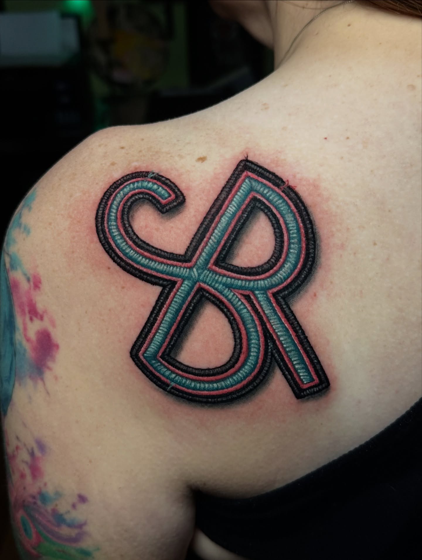 Lettering lettering script tattoo on the shoulder by Trevor Burtz