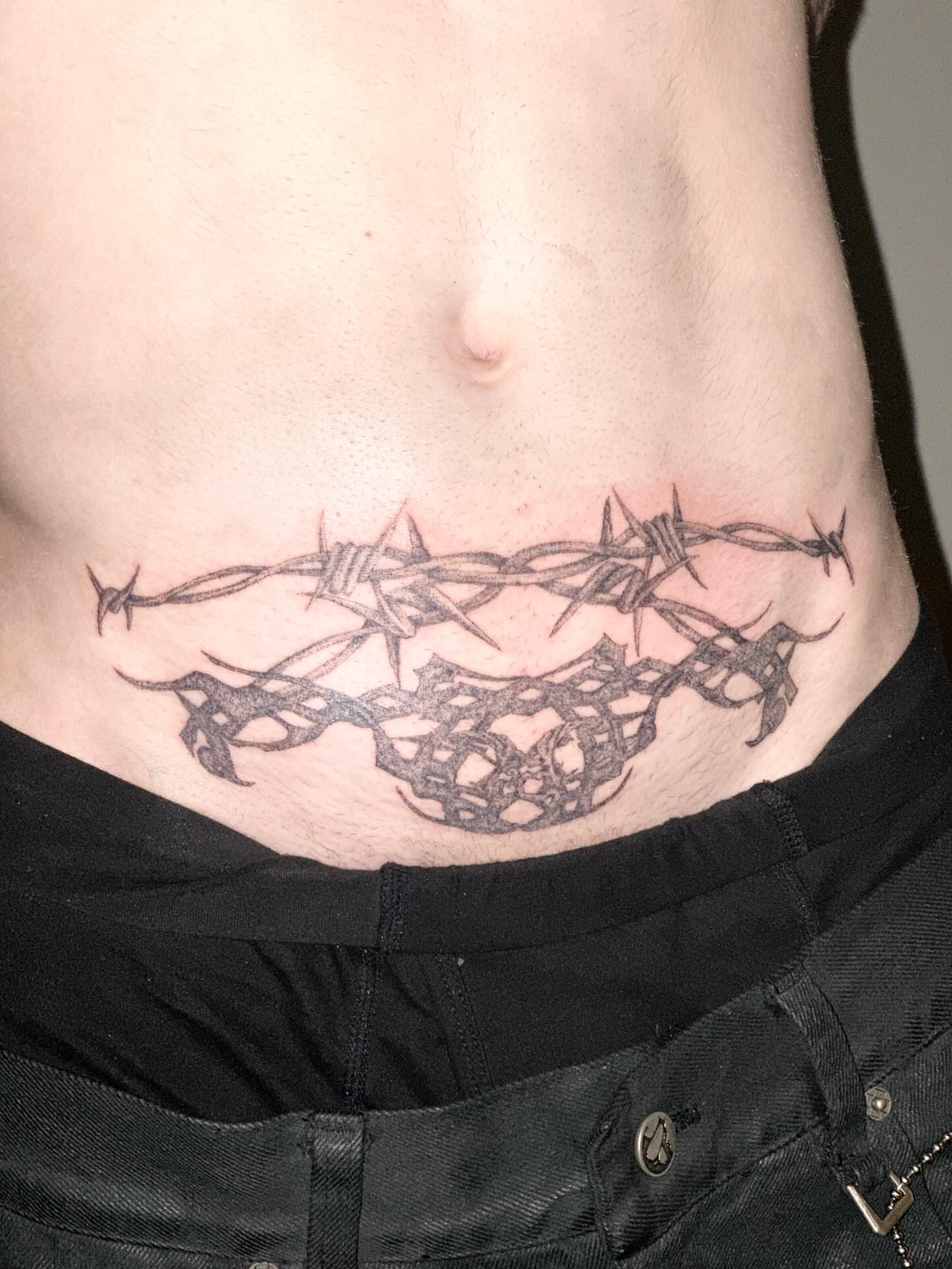 Barbed wire black and grey tattoo on the torso by Gregory Bramble Tattoo ๐ด๓ ง๓ ข๓ ฅ๓ ฎ๓ ง๓ ฟ