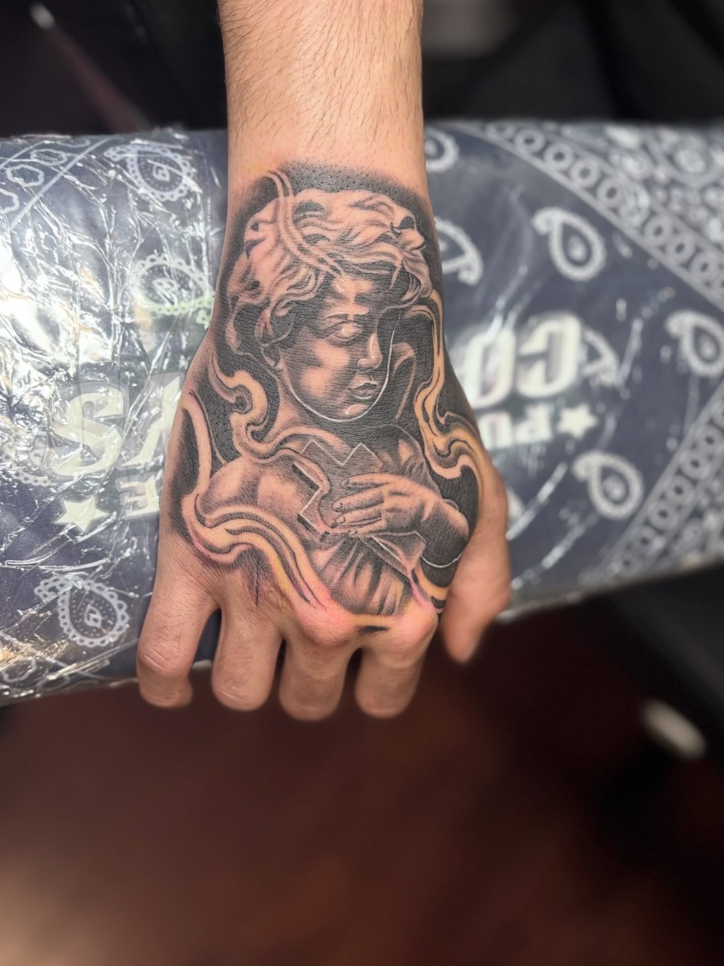 Cherub realism tattoo on the hand by @tattoosbyadrian