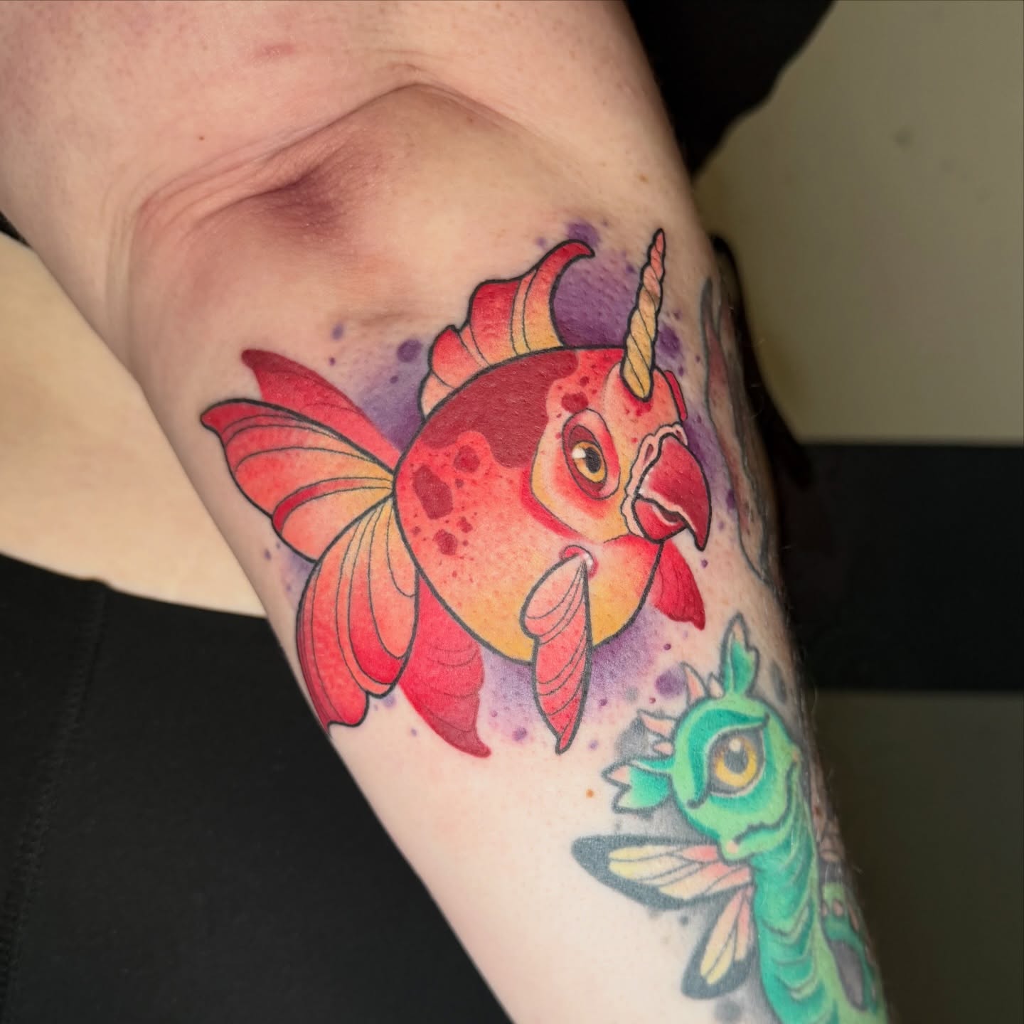 Goldfish watercolor tattoo on the forearm by Sam Castro