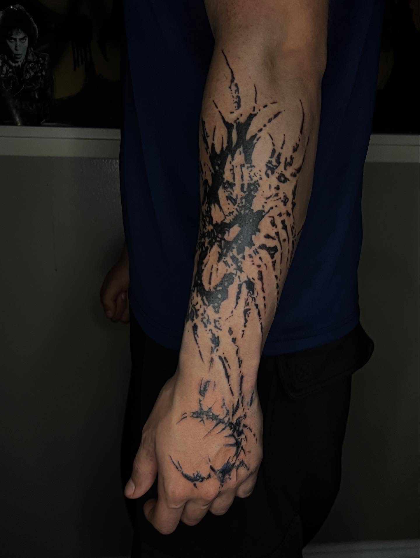 Abstract splatter dotwork tattoo on the forearm by @halfwit__