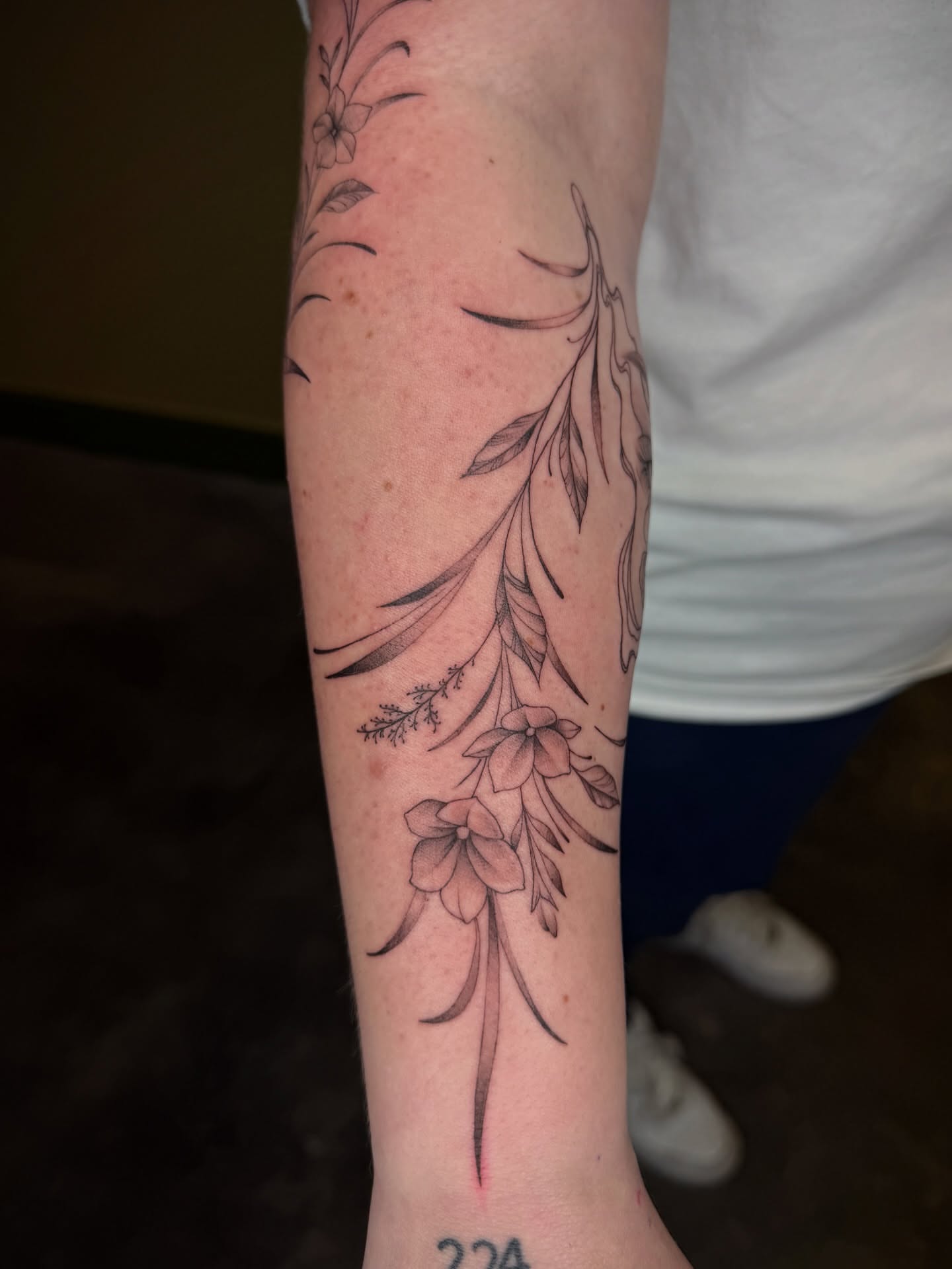 Floral arrangement black and grey tattoo on the forearm by Fabian💉 Tattoo artist