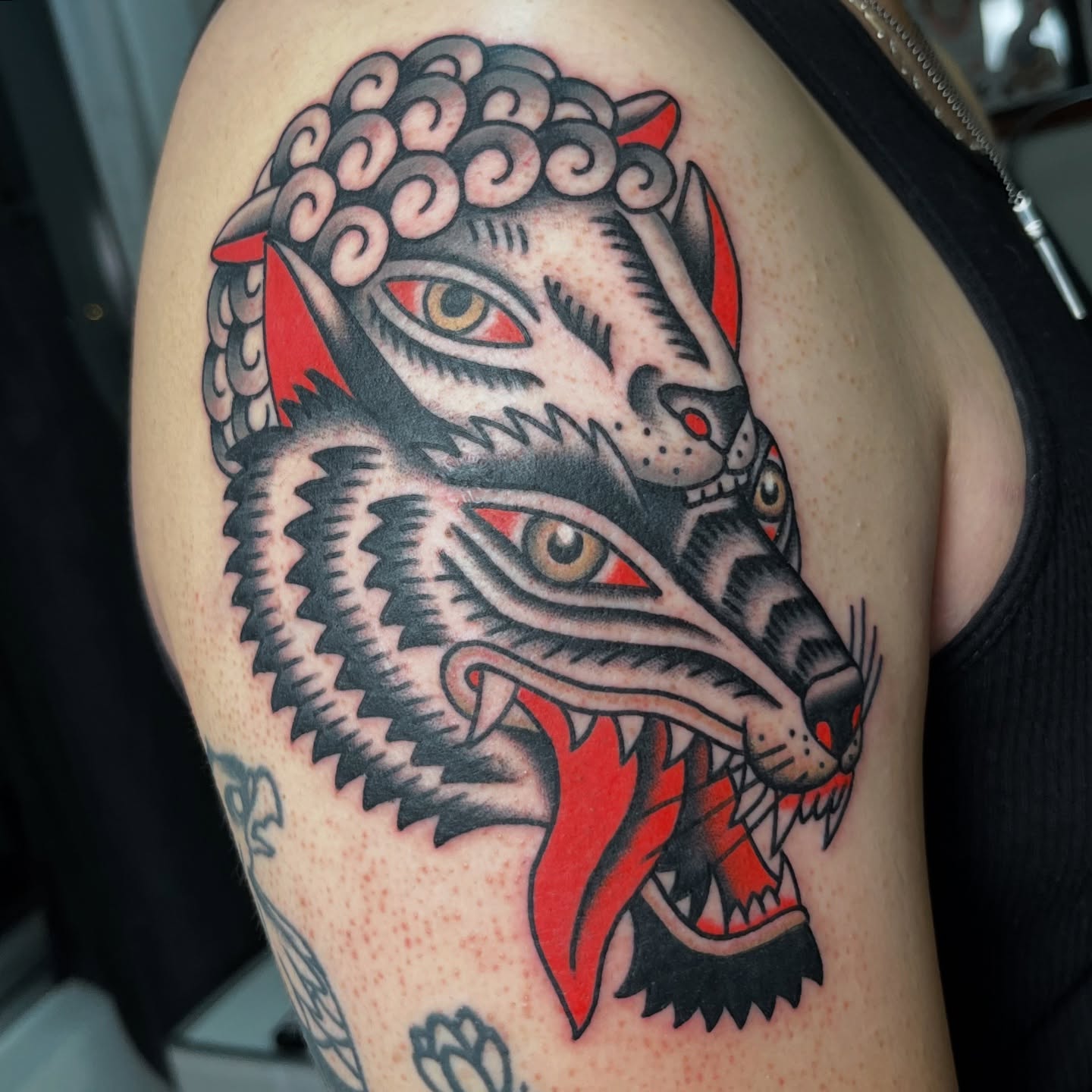 Wolf American traditional tattoo on the shoulder by andrewtattoos