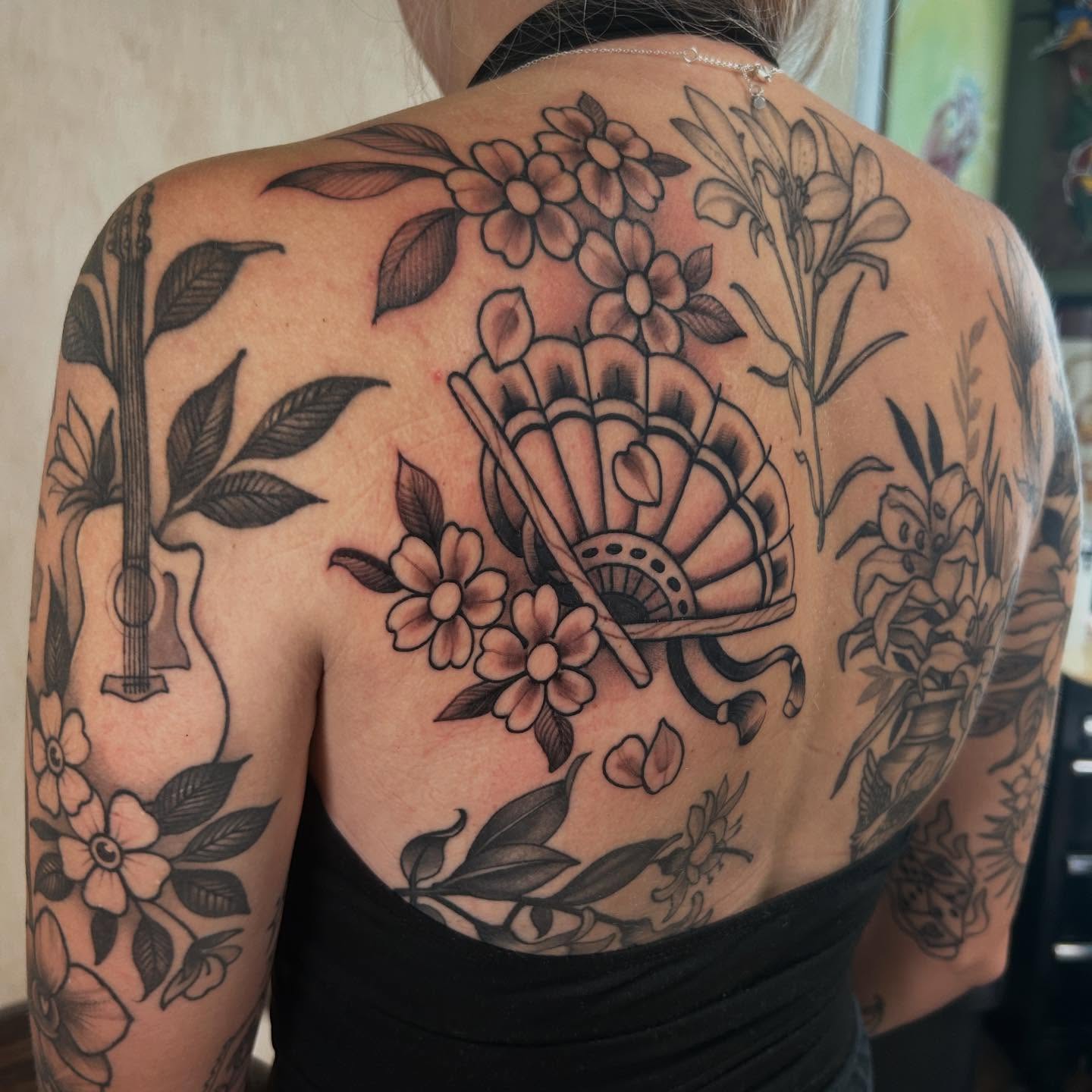 Fan and floral bouquet American traditional tattoo on the back by Katie Dexter, Des Moines, Iowa