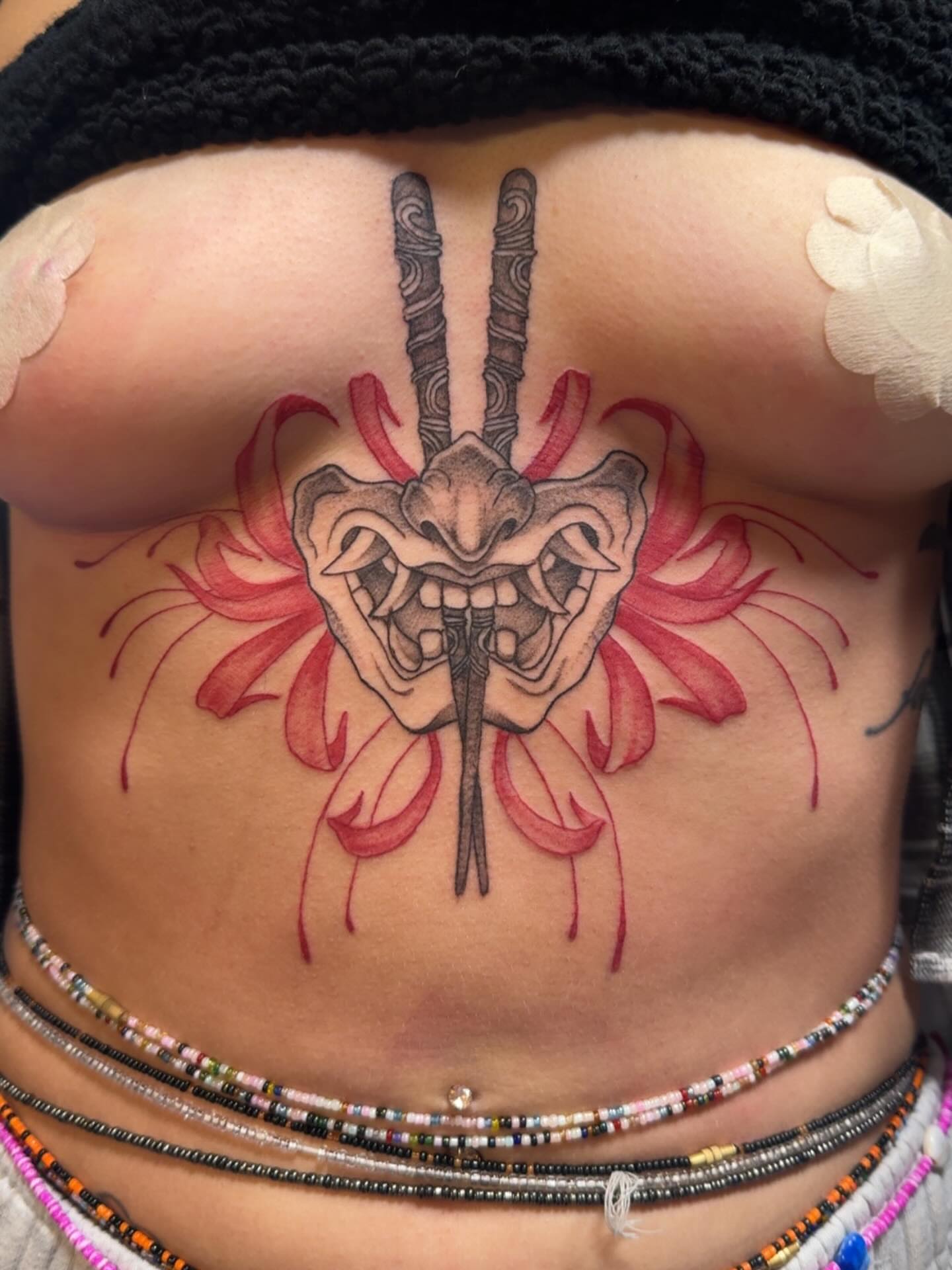 Skull with horns neo-traditional tattoo on the torso by Lindsay