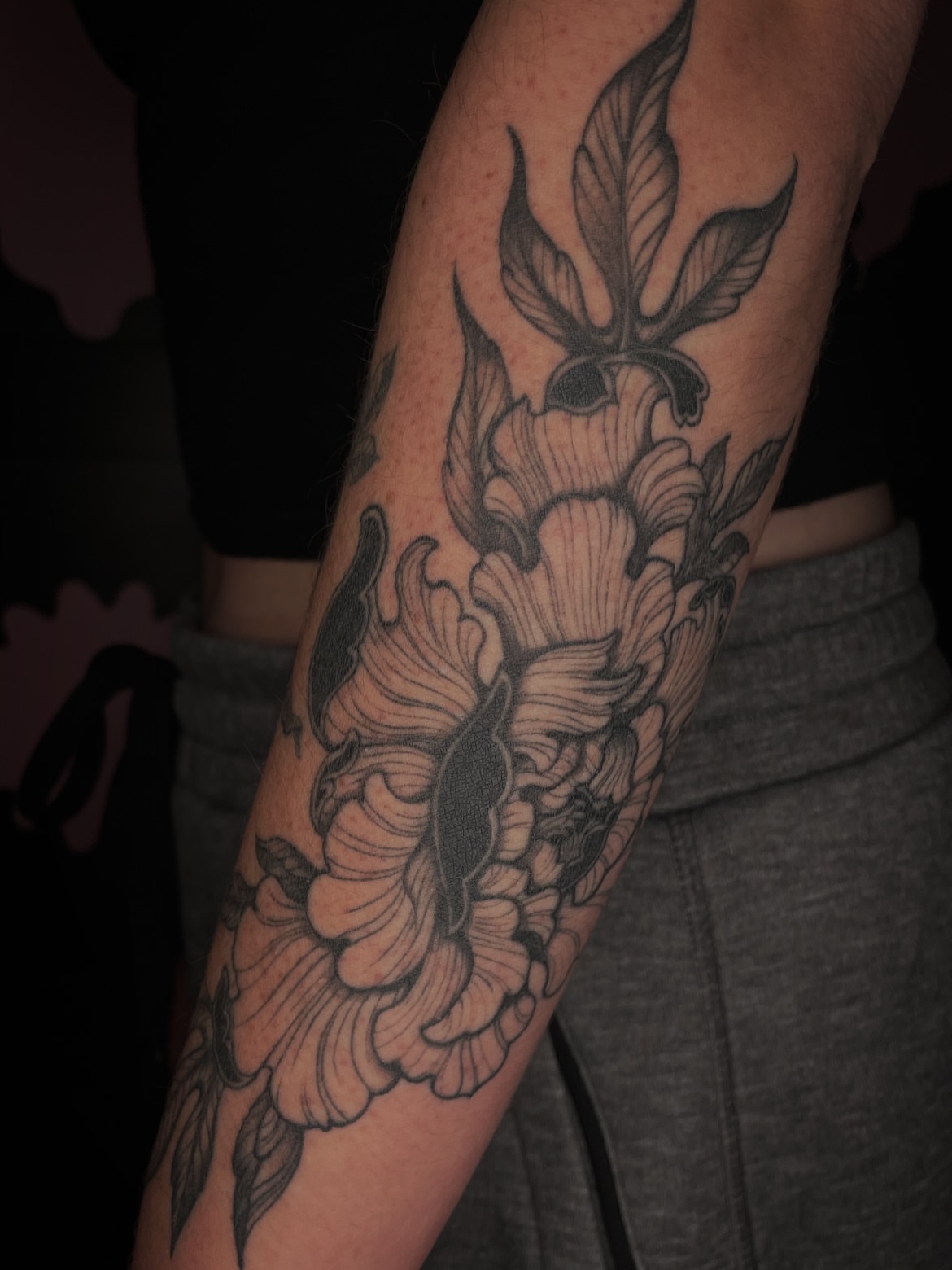 Floral bouquet black and grey tattoo on the forearm by Eryn, Portland, Oregon