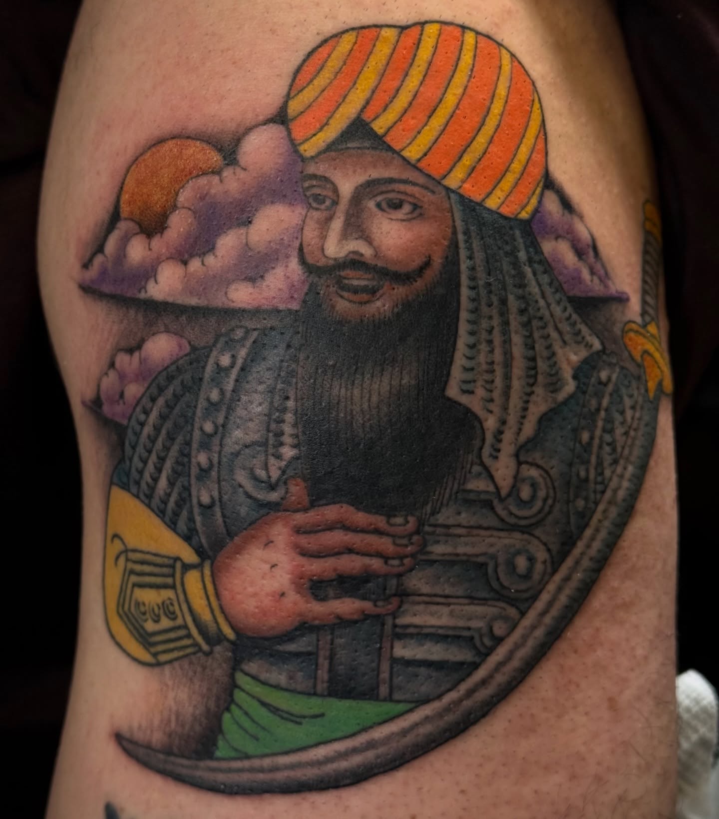 Sikh warrior realism tattoo on the upper arm by Candi Kinyōbi