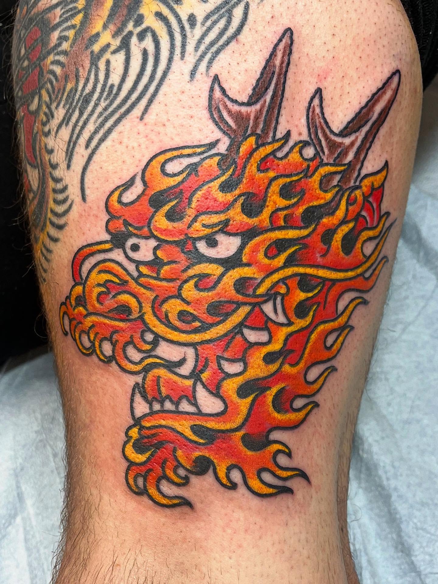 Flaming dragon head American traditional tattoo on the forearm by Graham Niles