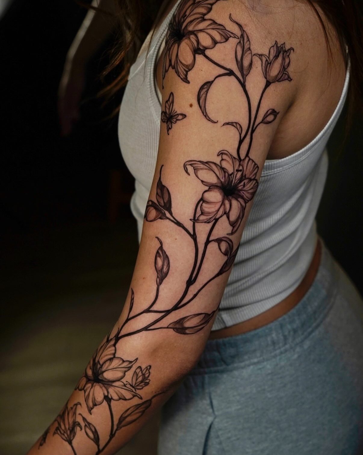 Floral vine black and grey tattoo on the forearm by Nicki Yến