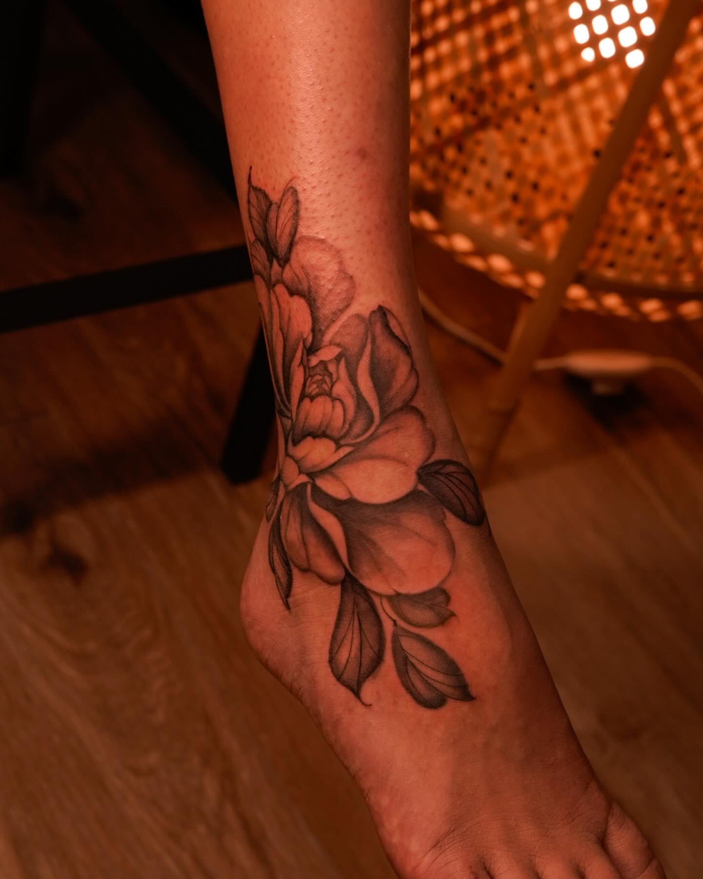 Flower black and grey tattoo on the foot by Nicki Yến