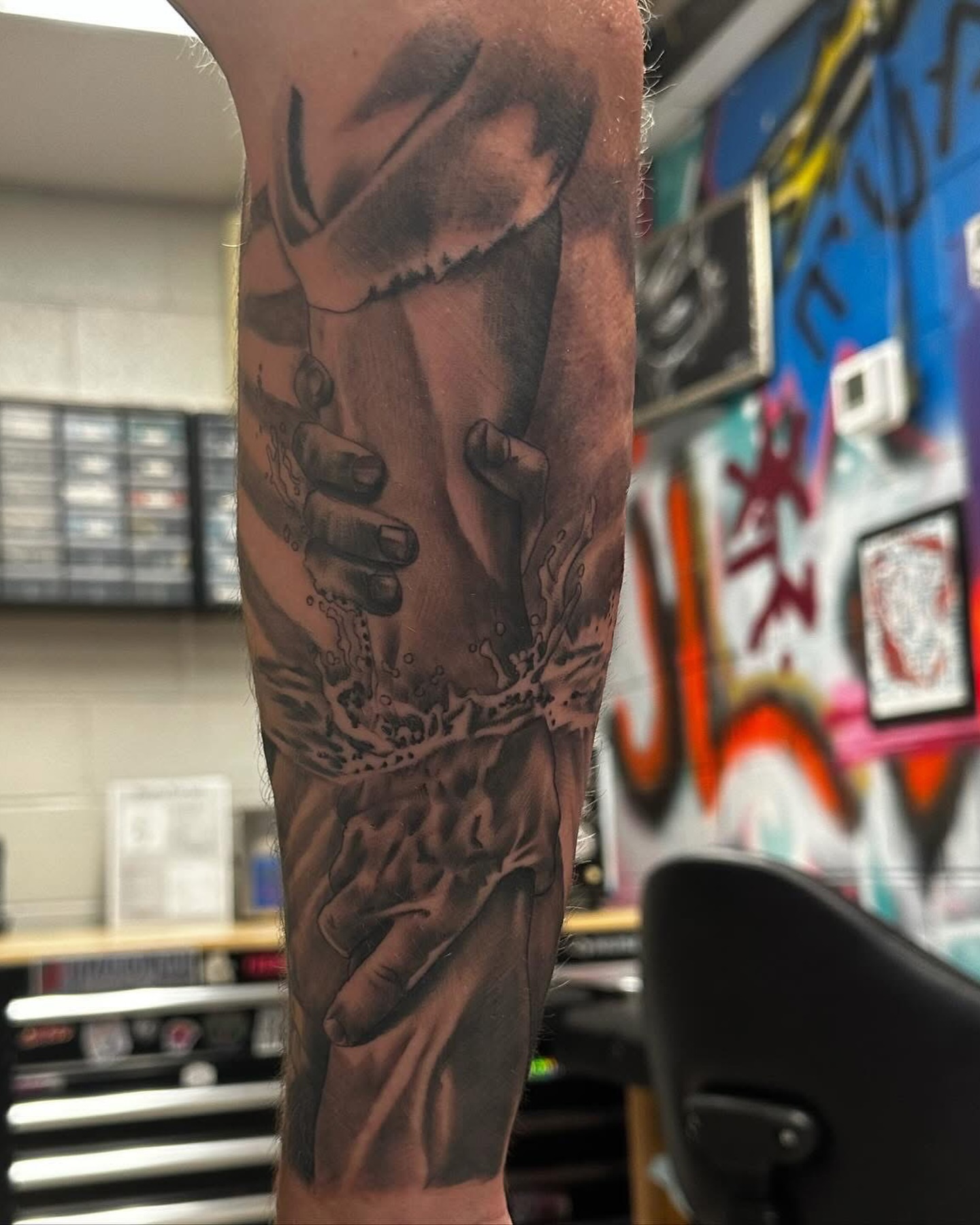 Hands and water realism tattoo on the forearm by Isaac Ortiz-Riendeau