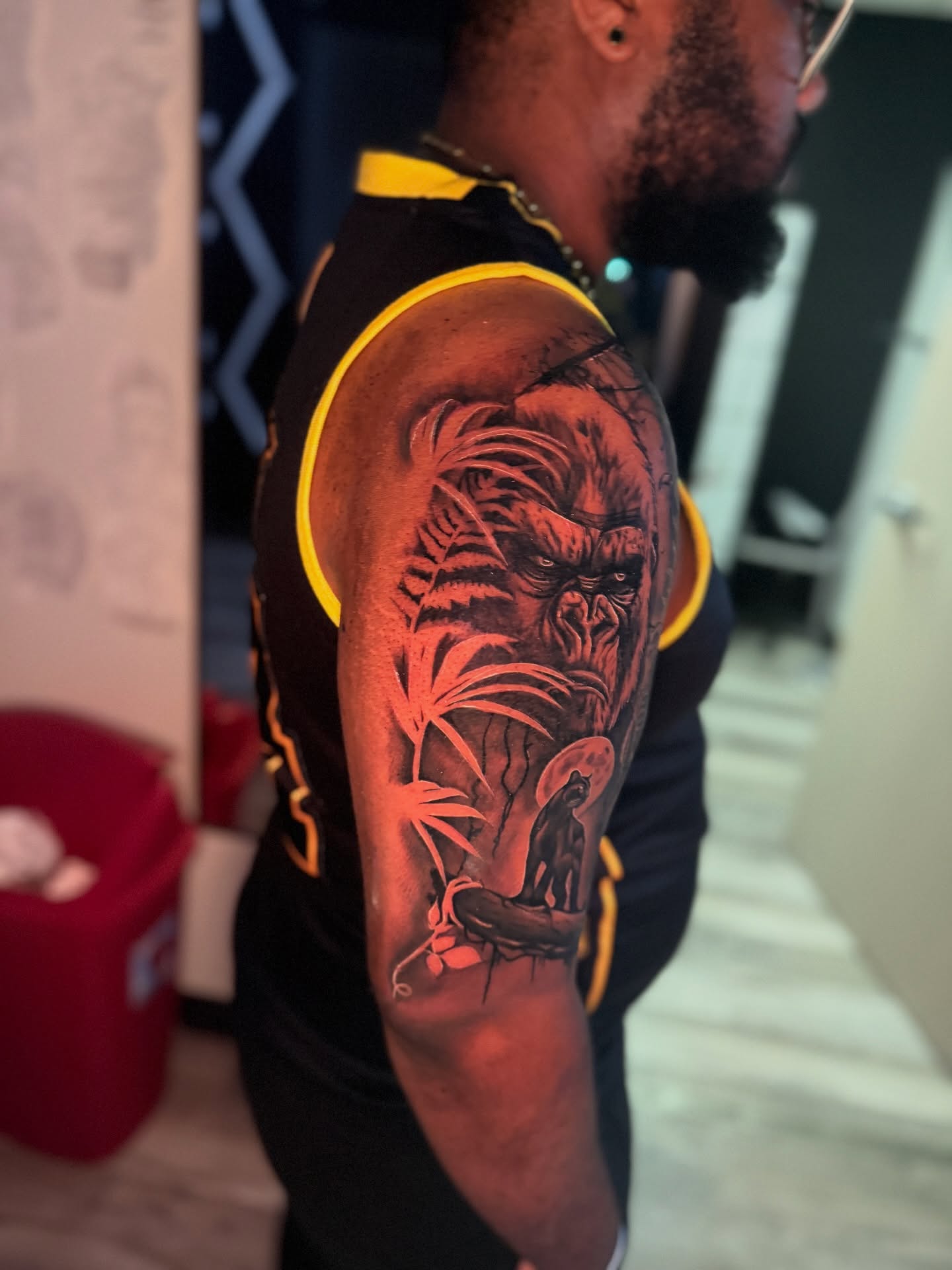 Gorilla and woman realism tattoo on the upper arm by Atlanta Tattoo Artist