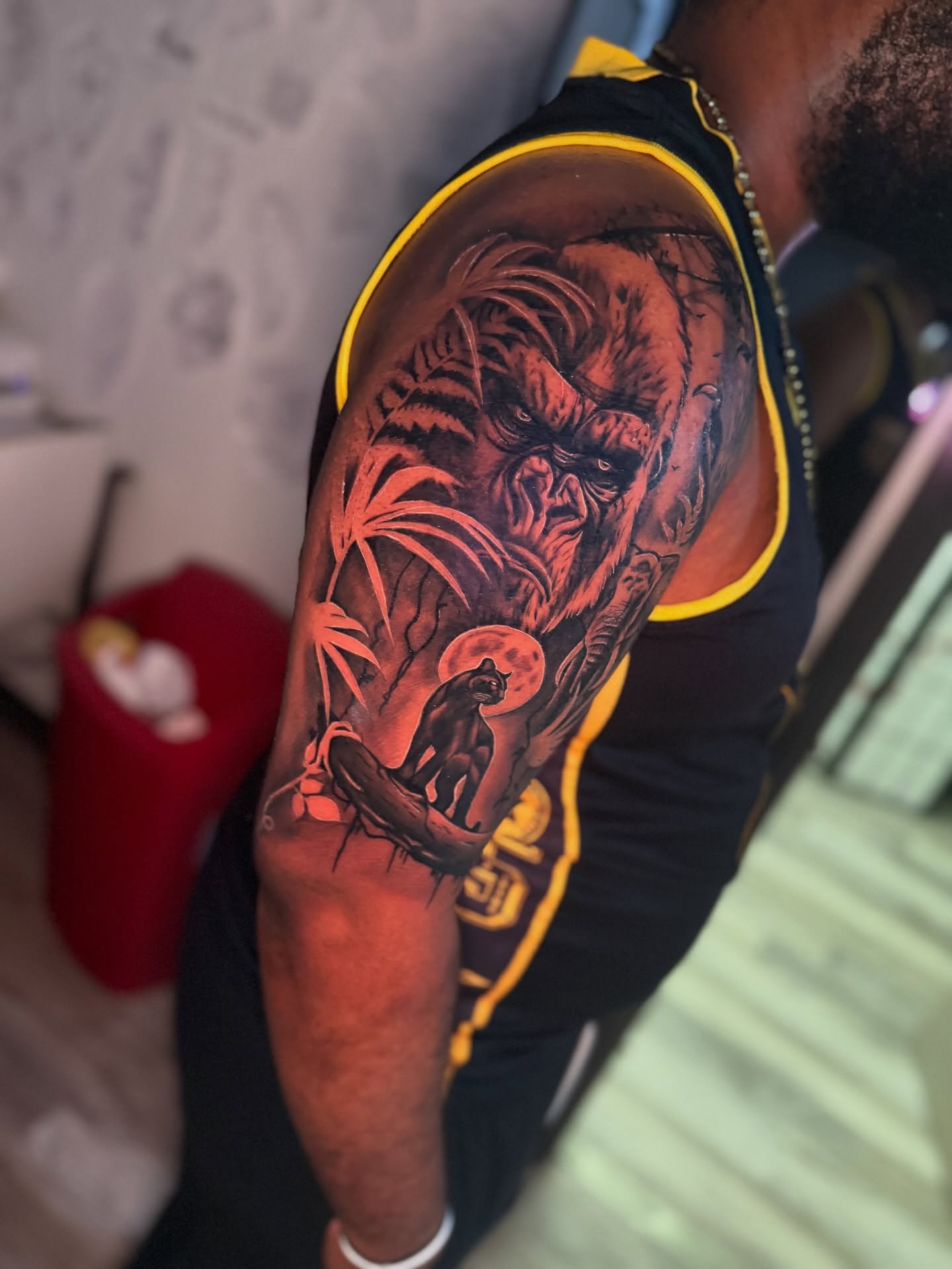 Gorilla and panther realism tattoo on the upper arm by Atlanta Tattoo Artist