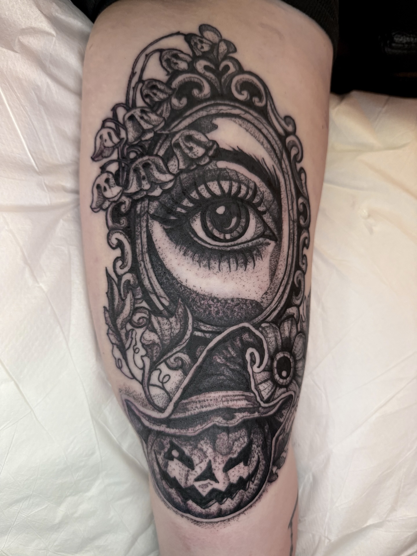 Eye with floral frame realism tattoo on the forearm by amanda malia wega