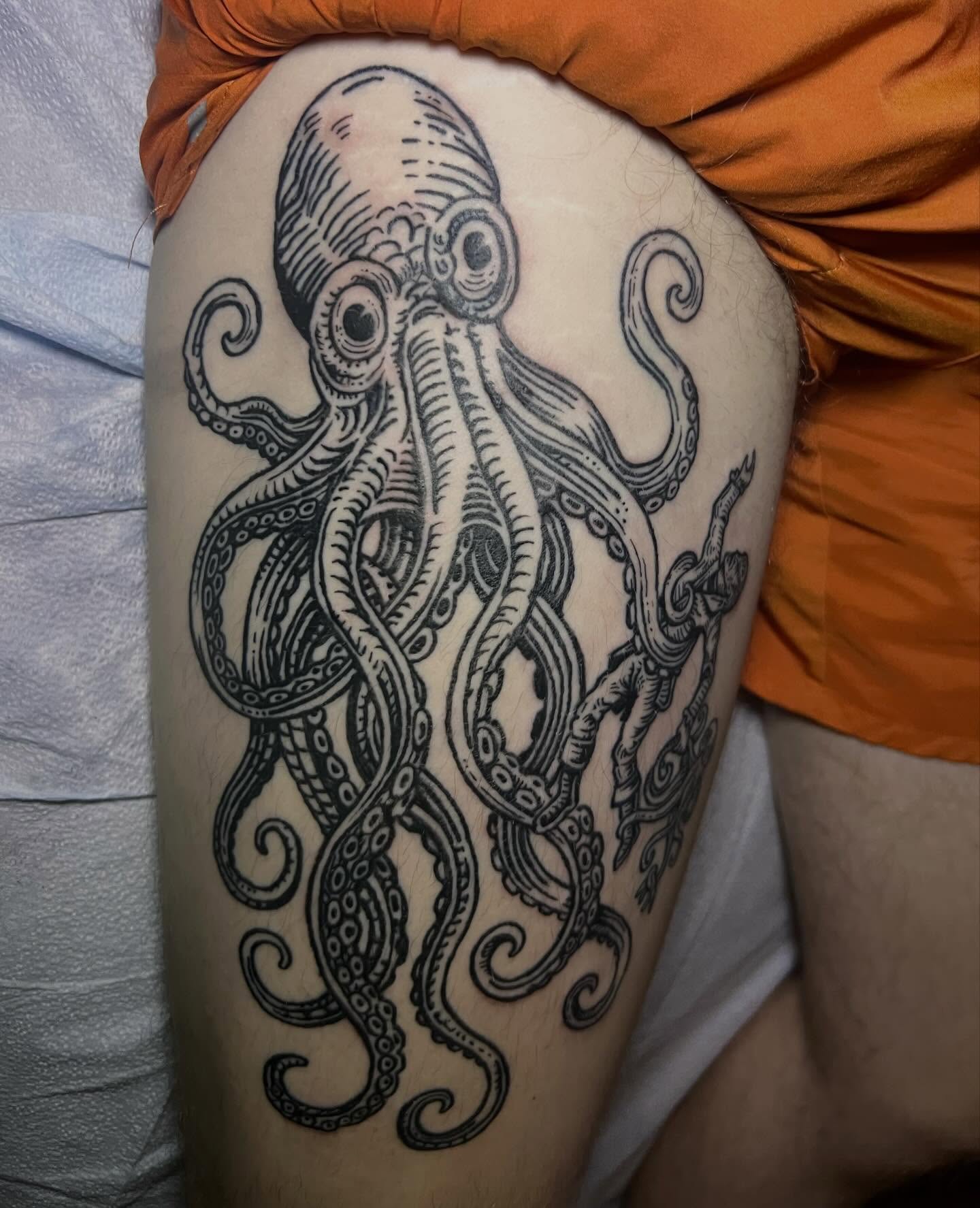 Octopus black and grey tattoo on the thigh by Jason Middelton
