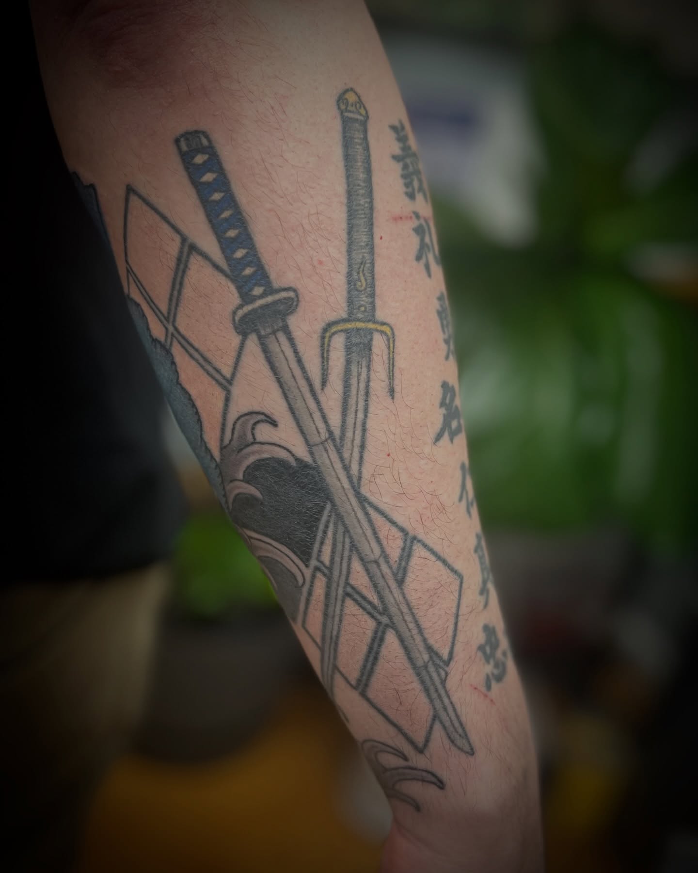 Katana swords black and grey tattoo on the forearm by Garden Glow Tattoo